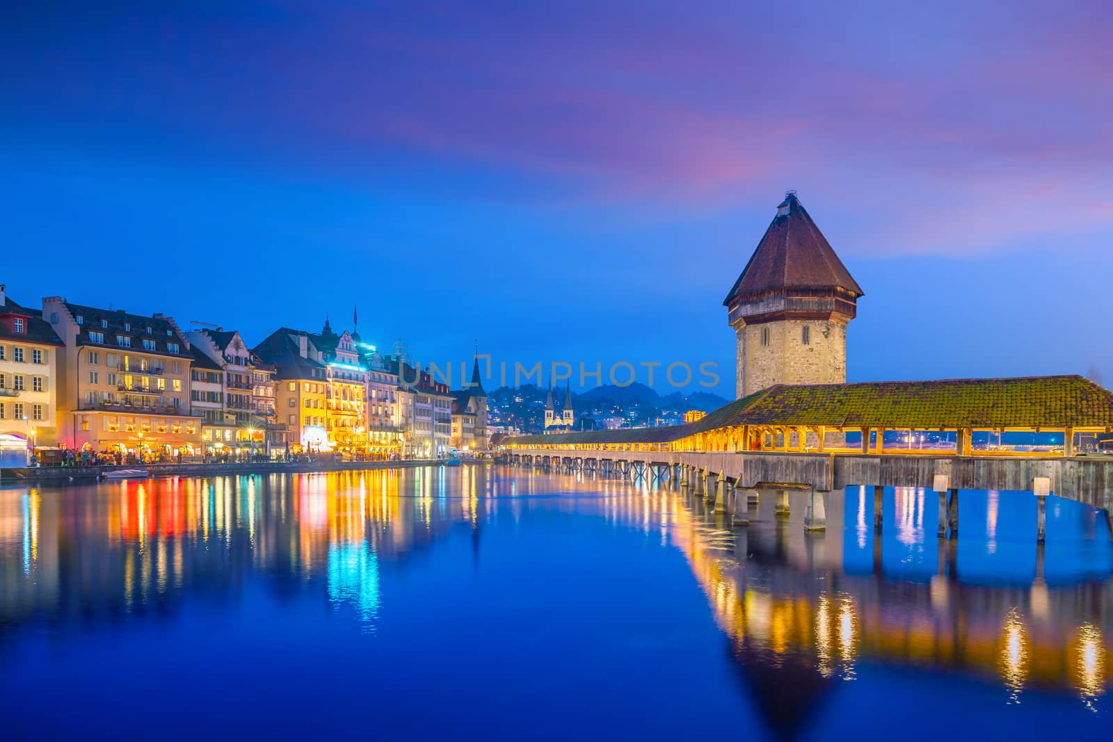 Historic city center of downtown Lucerne with  Chapel Bridge and lake Lucerne in Switzerland at sunset