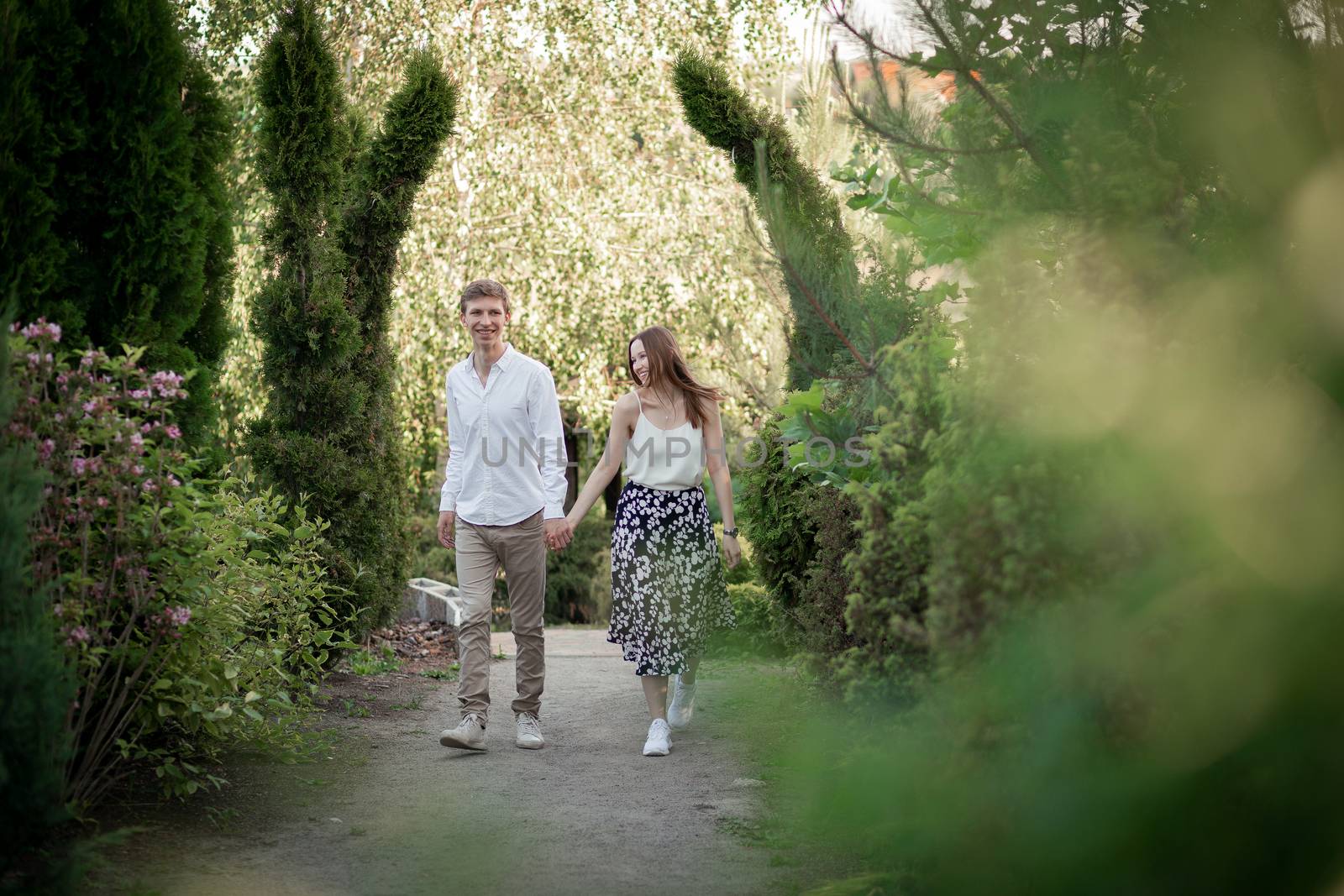 The young couple walking in the park