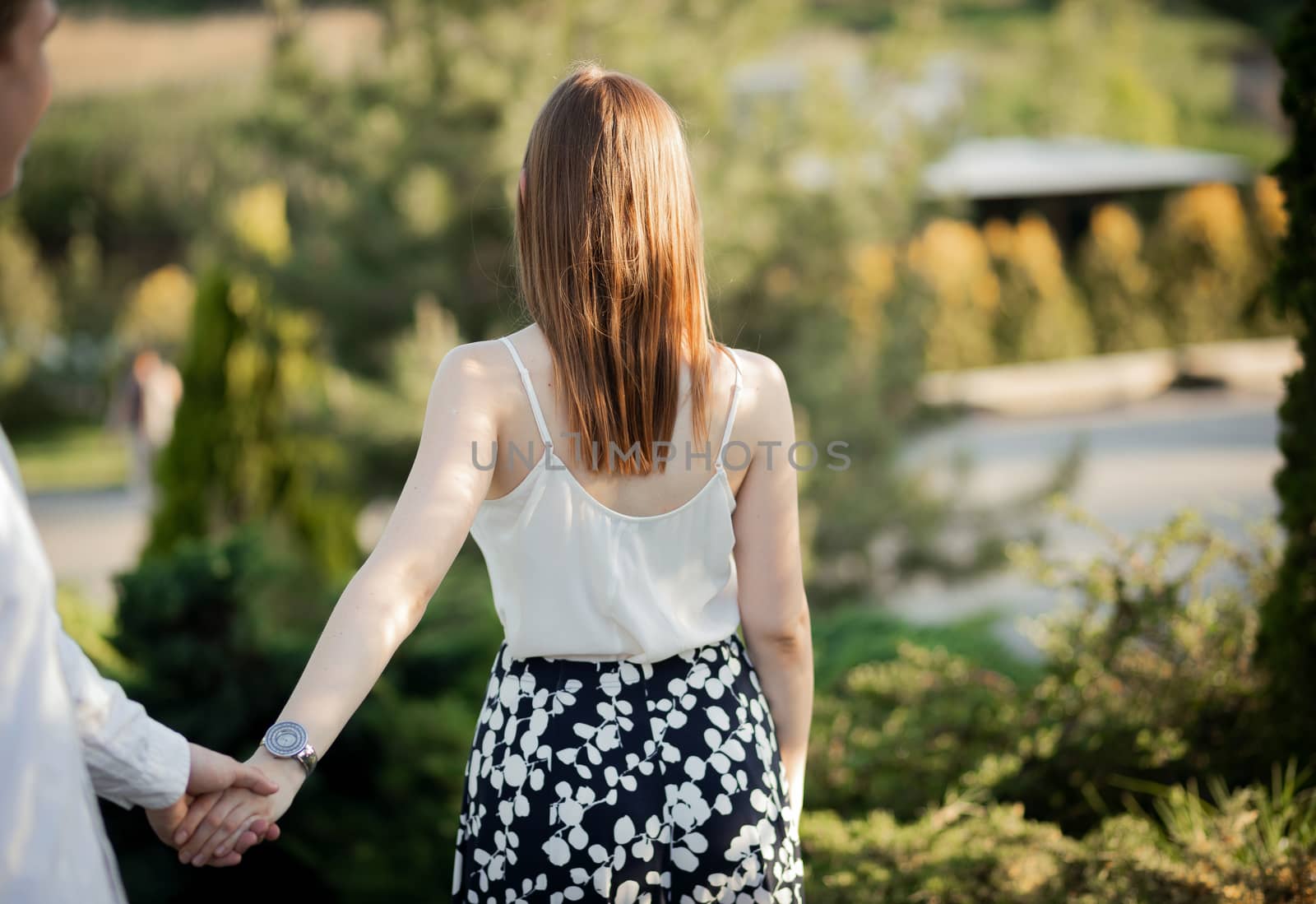 The young couple walking in the park