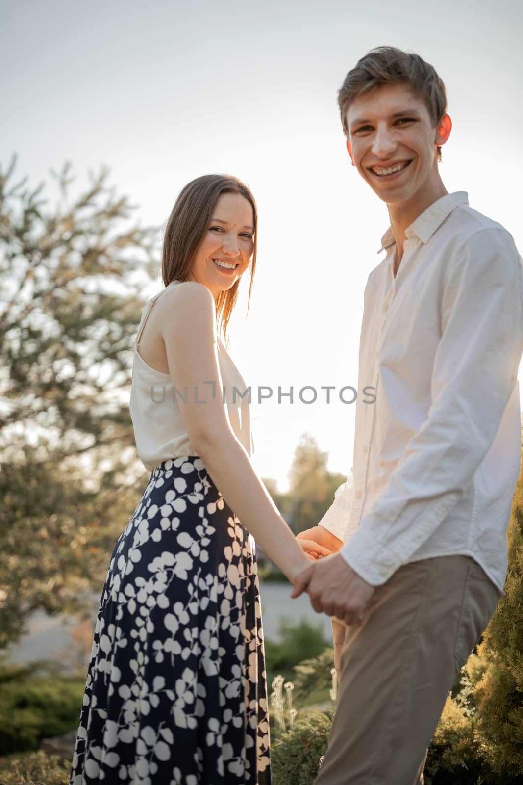 The young couple walking in the park