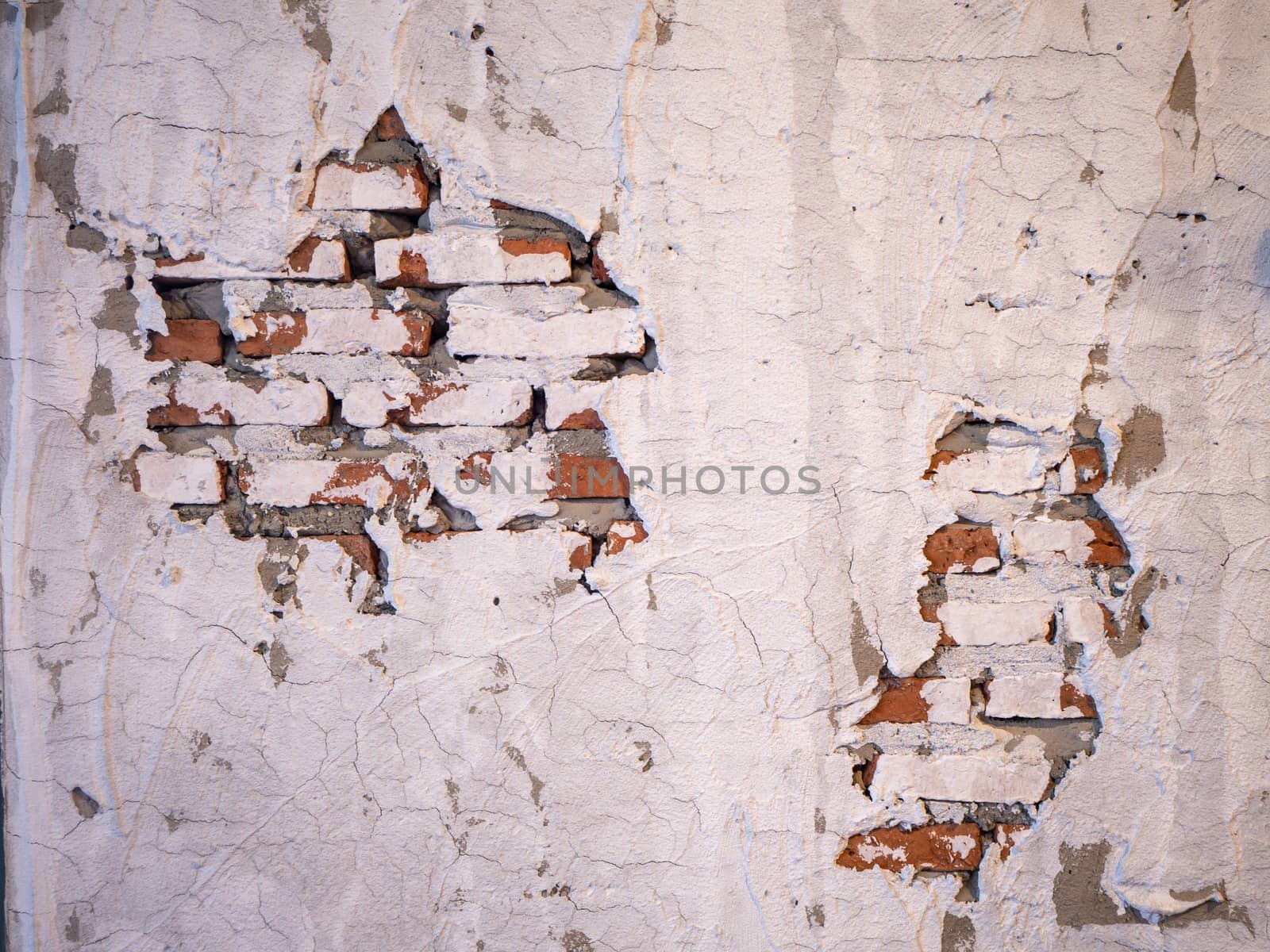 Old brick wall with peeling plaster for background by shutterbird