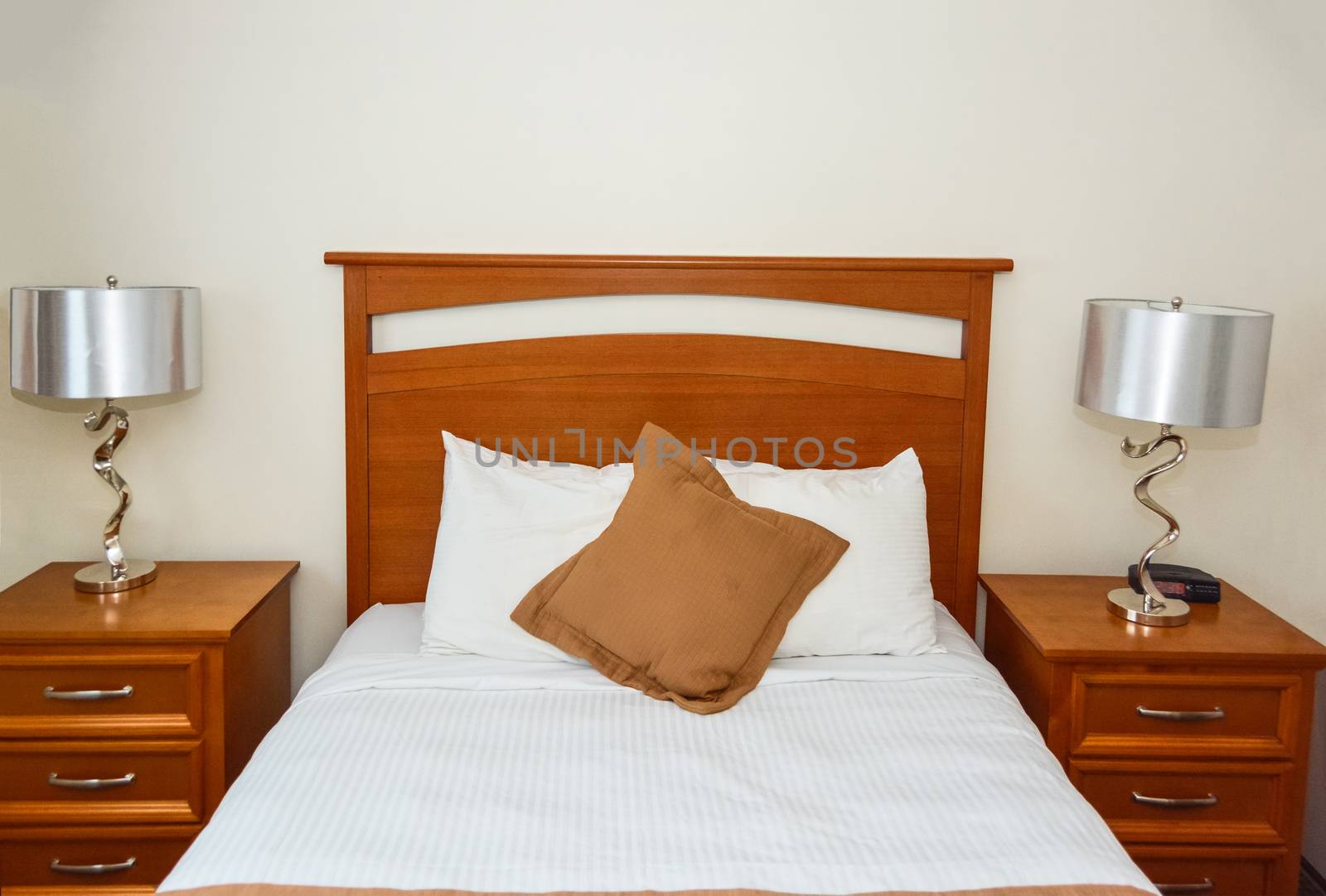 Double bed in the bedroom with the lamp on bedside tables