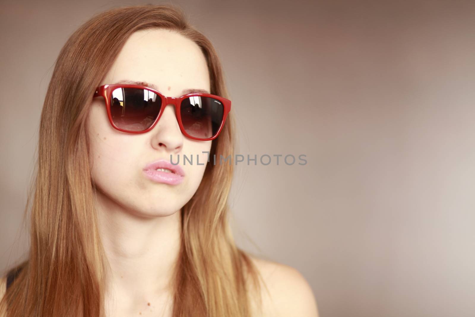 Girl in glasses. Girl portrait in red glasses. Beautiful young curious woman. Woman watching.