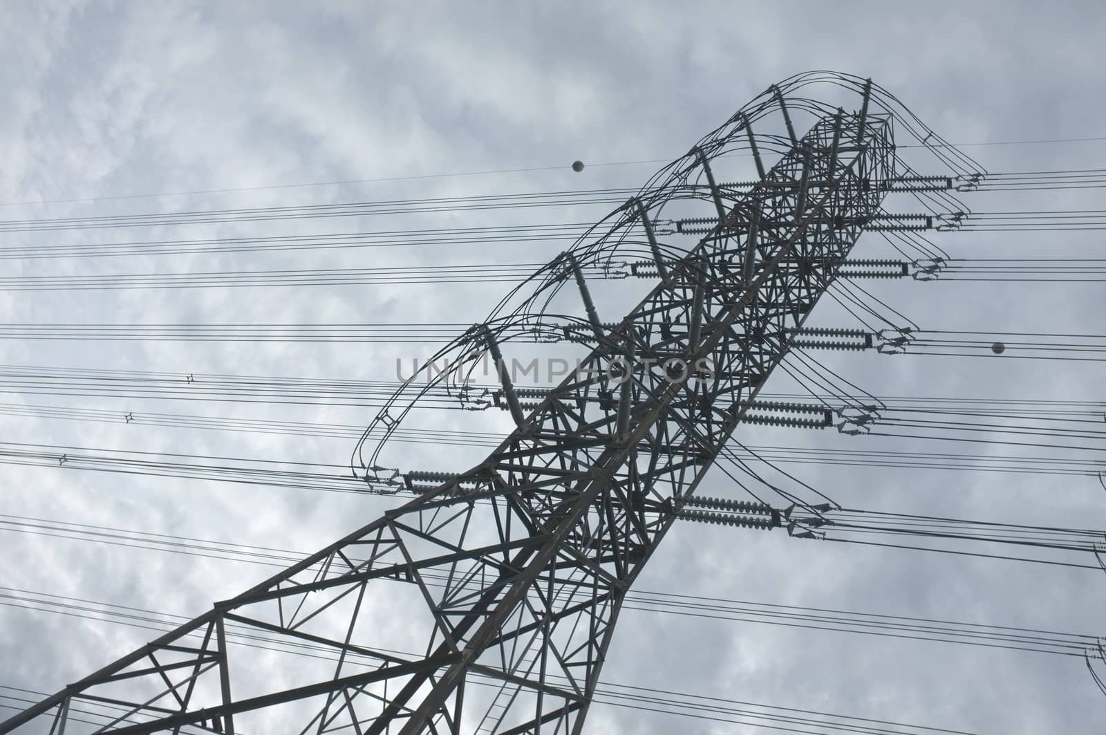 Close up view , high voltage power lines station. High voltage electric transmission pylon silhouetted tower.