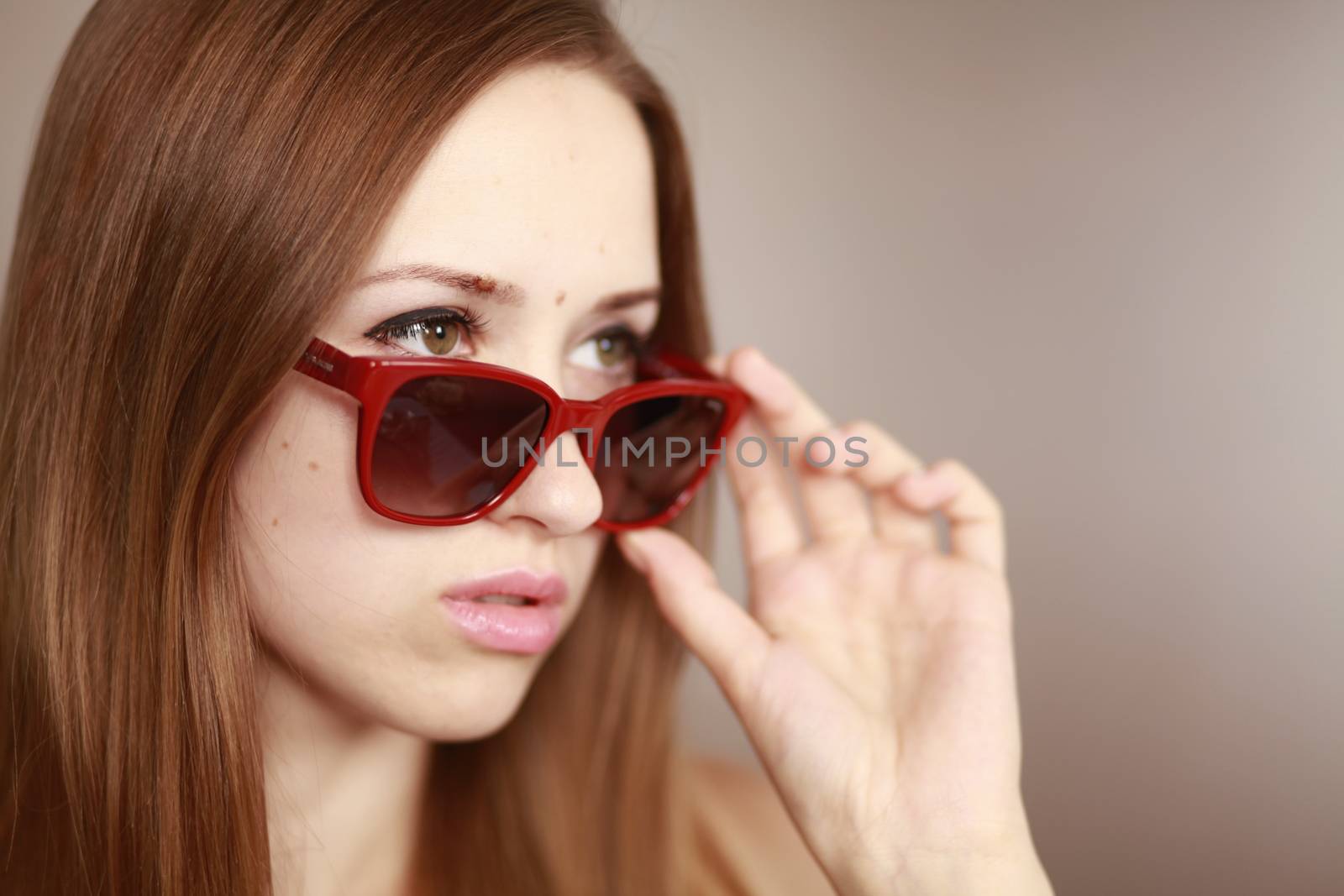 Girl in glasses. Girl portrait in red glasses. Beautiful young curious woman. Woman watching.
