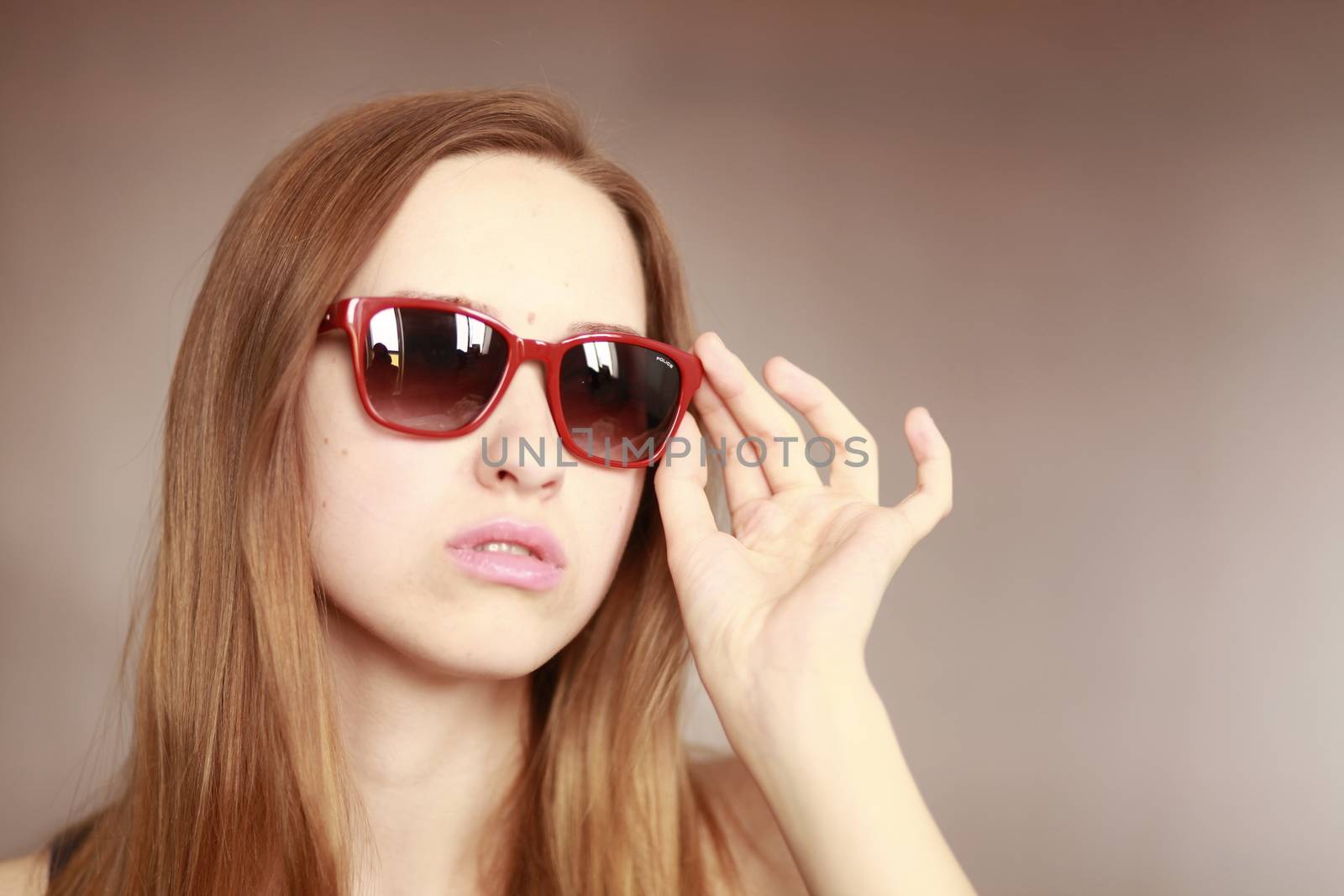 Girl in glasses. Girl portrait in red glasses. Beautiful young curious woman. Woman watching.