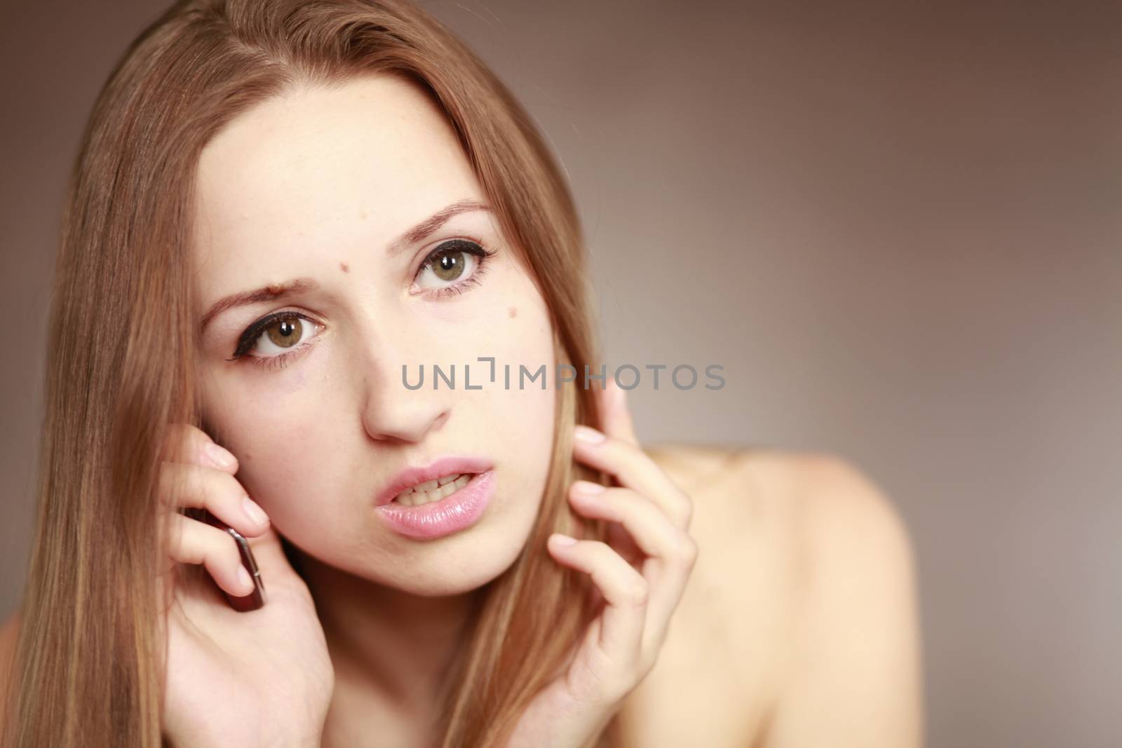 The beautiful girl is talking on the mobile phone. Girl portrait. Woman portrait.