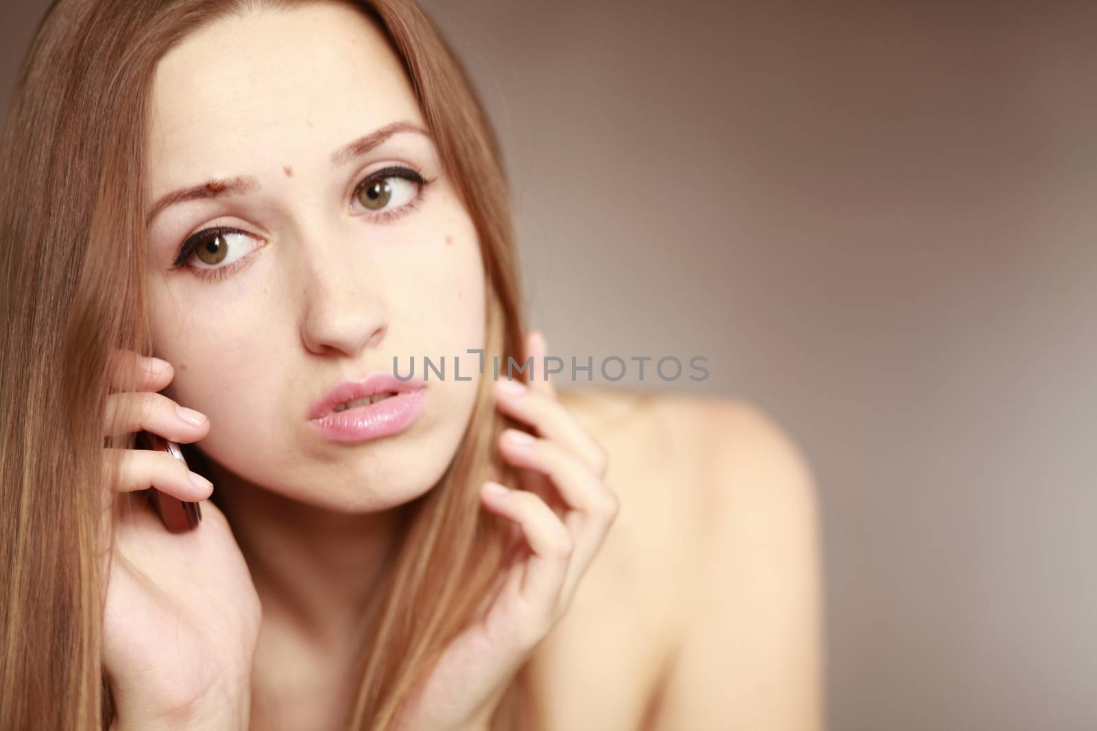 The beautiful girl is talking on the mobile phone. Girl portrait. Woman portrait.