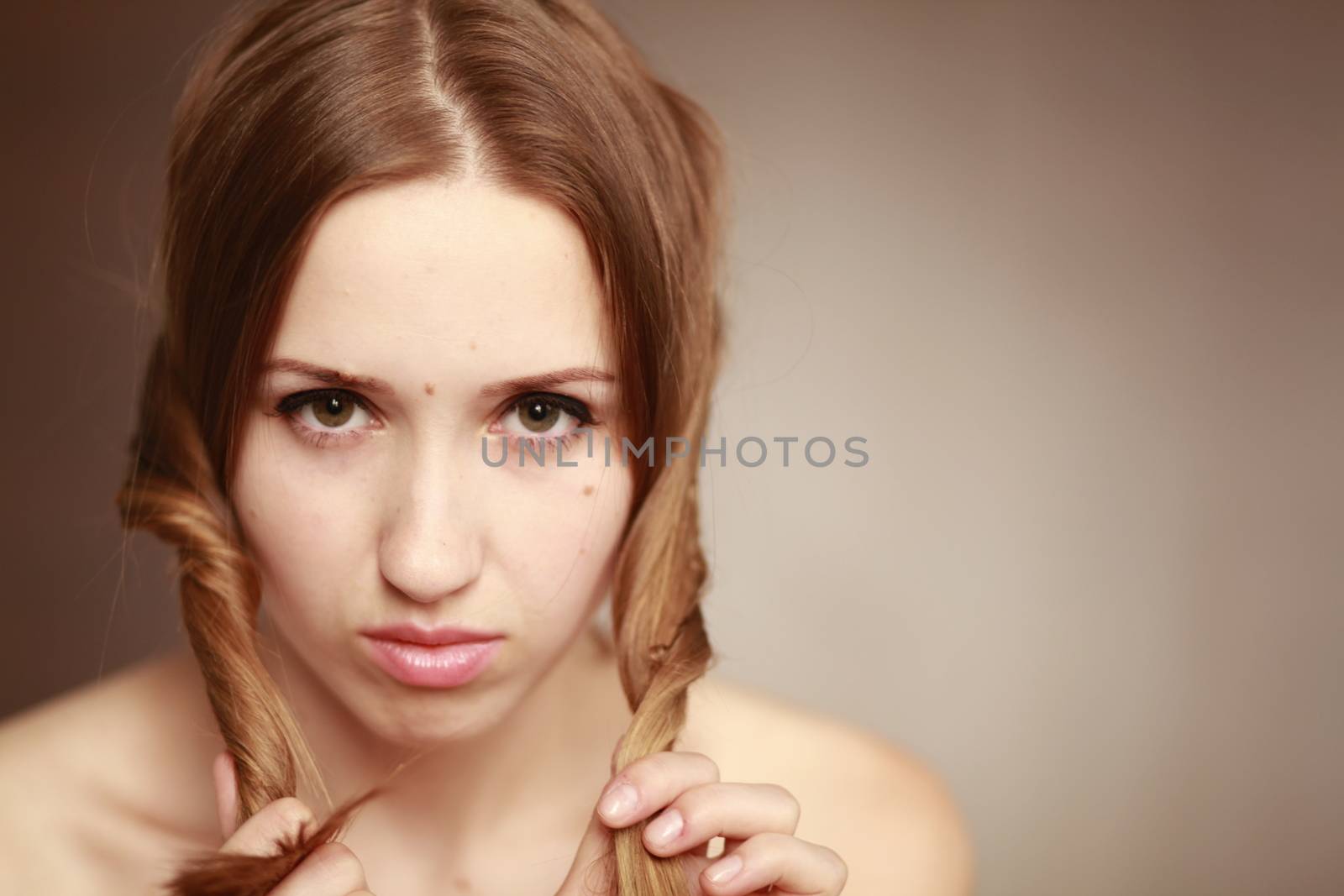 Emotional girl portrait on the brown background