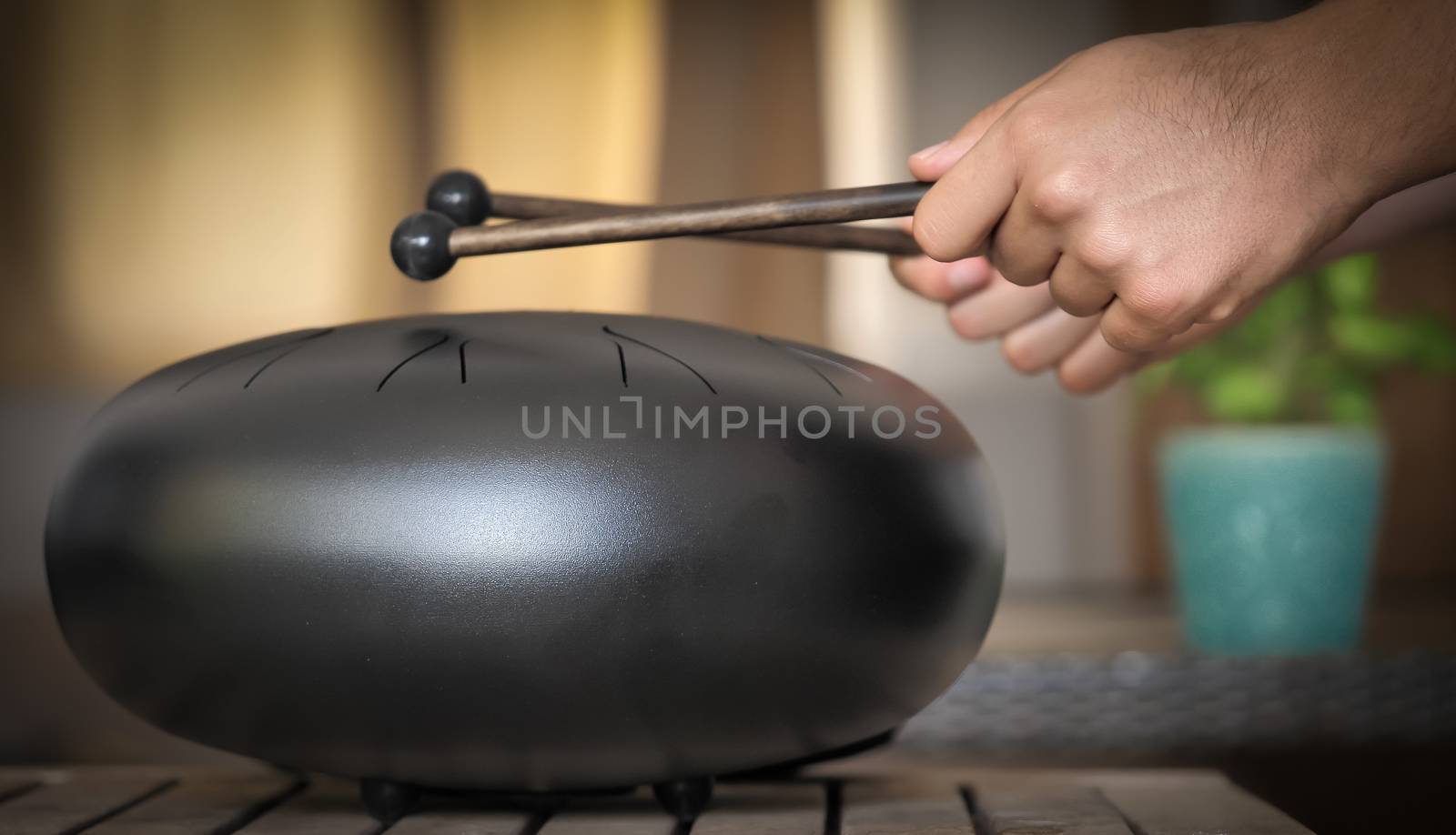 Steel tongue drum rare music playing instrument, made from propane tank and also known as tank drum or hank drum similar to Pantam. Selective focus and motion blur.