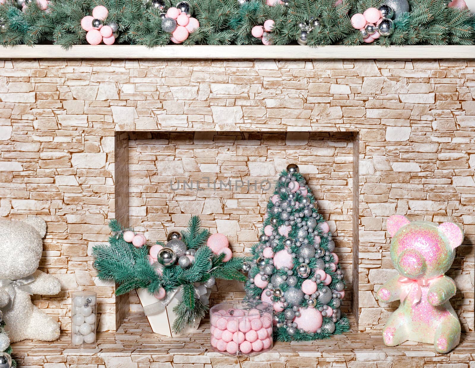 Decorative fireplace with gifts, Christmas trees, toys, balls and fir branches on the eve of Christmas and New Year. by Sergii