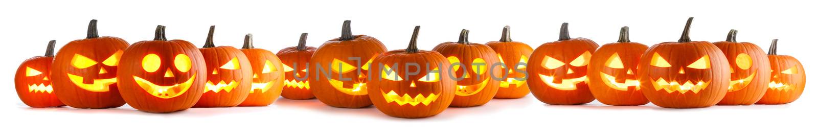 Many Halloween Pumpkins in a row isolated on white background