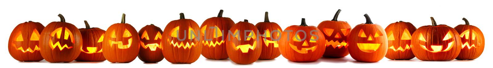 Many Halloween Pumpkins in a row isolated on white background