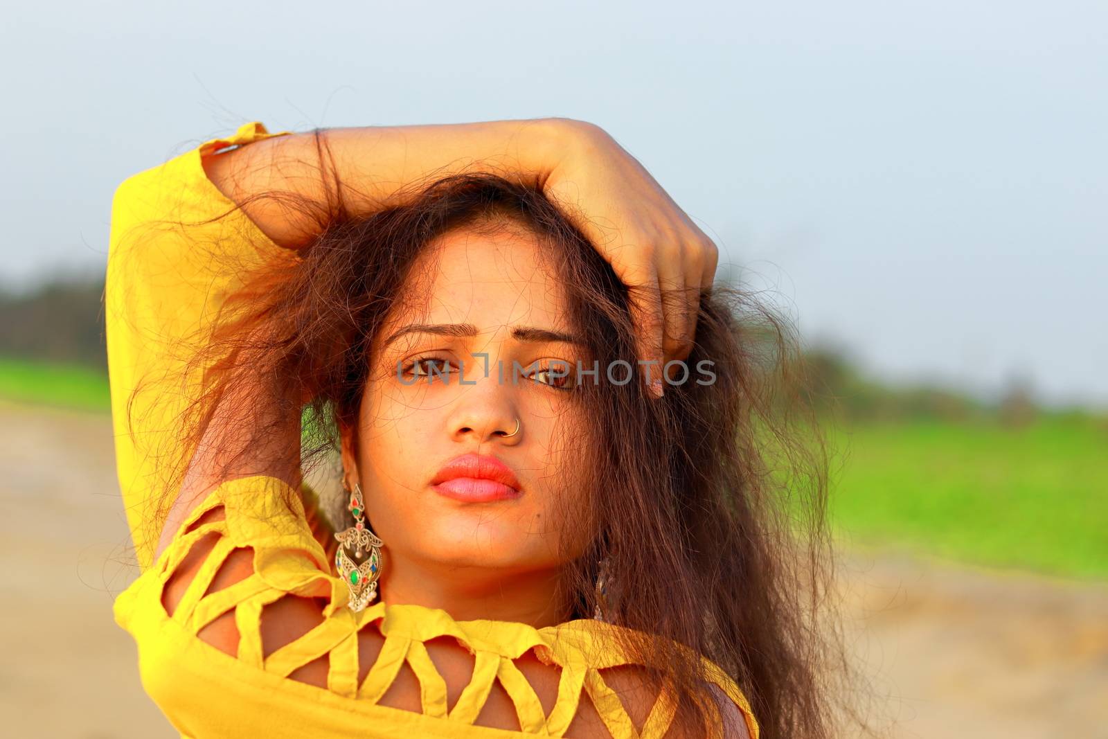A fashionable Indian model girl in yellow top by 9500102400