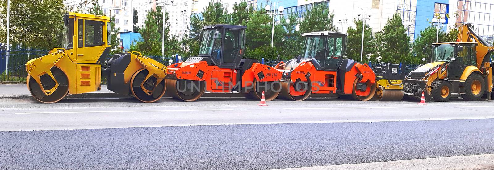 road machinery stands motionless on the road by the side of the by Grishakov