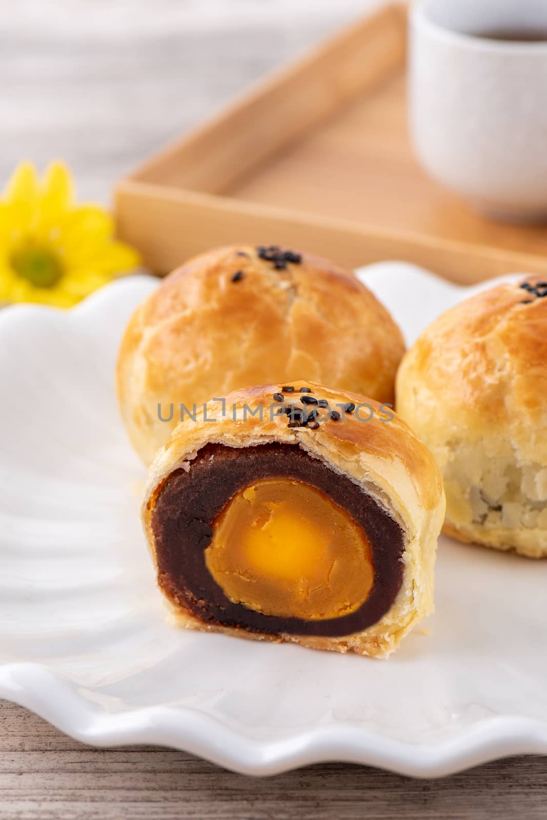 Moon cake yolk pastry, mooncake for Mid-Autumn Festival holiday, top view design concept on bright wooden table with copy space