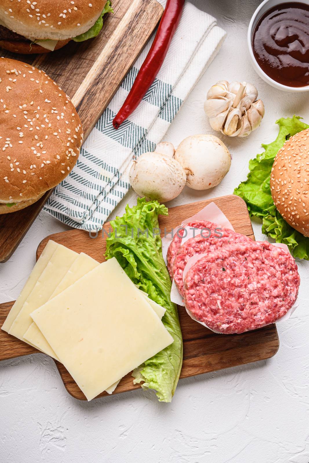 Set of burger raw ingredients and ground beef on white textured background, topview by Ilianesolenyi