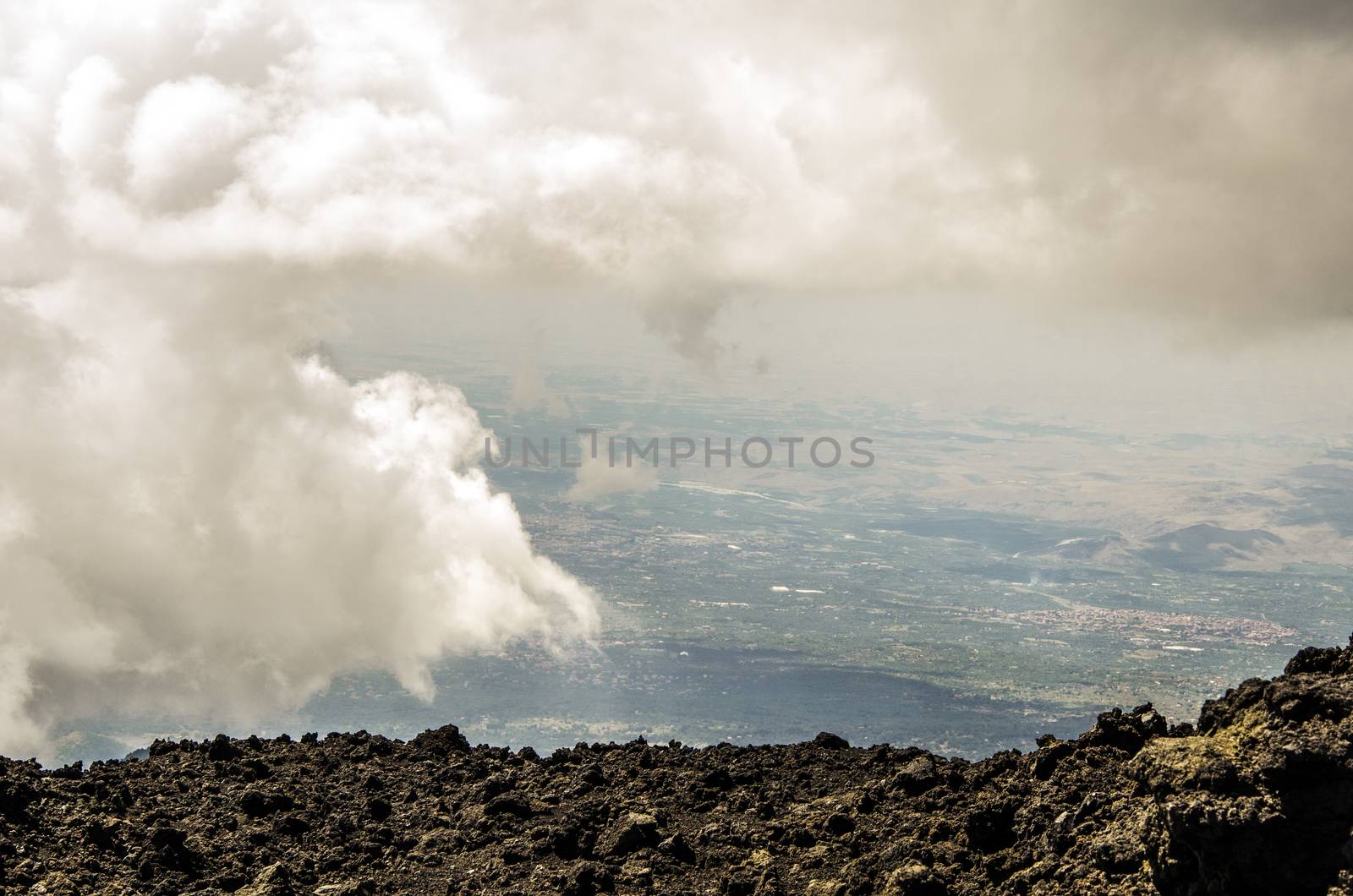 View between clouds from the top of the Etna volcano of Sicilian territory