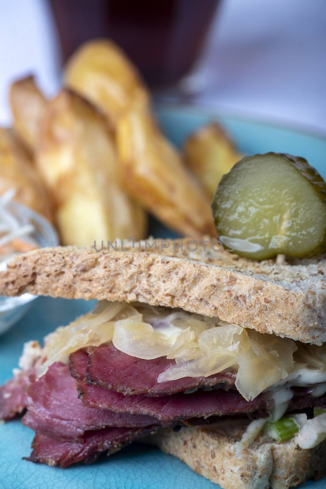 reuben sandwich on a plate with fries