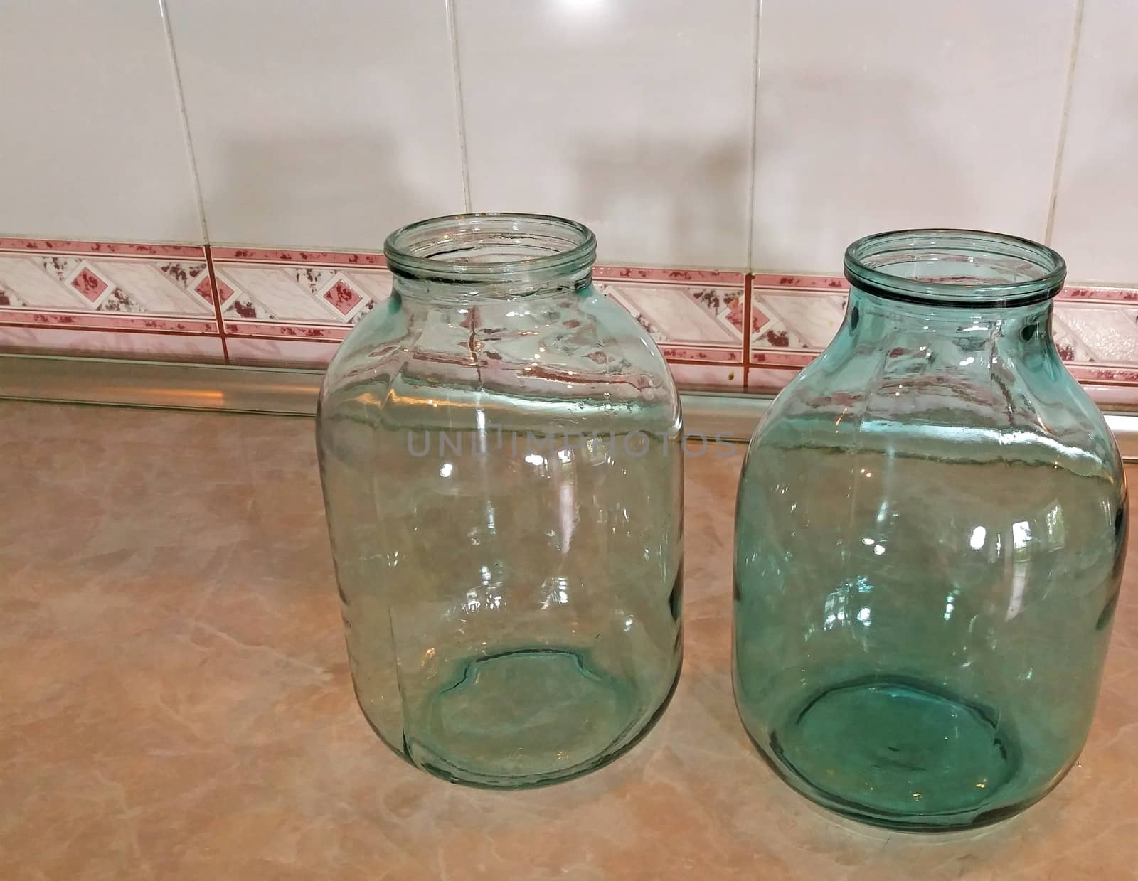 Glass jars 3 liters, capacity on the table in the kitchen