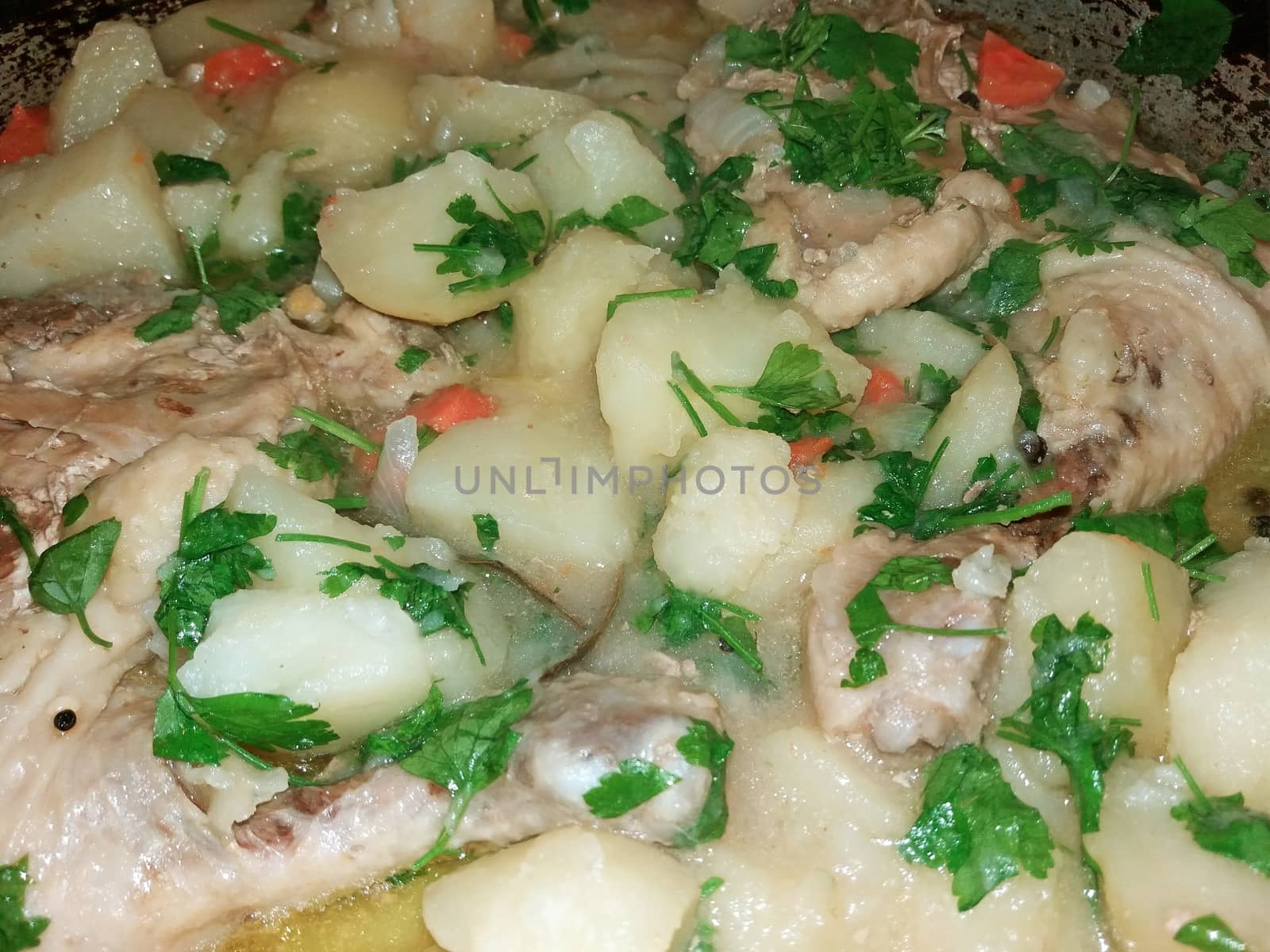 soup with meat, potatoes, and a little parsley