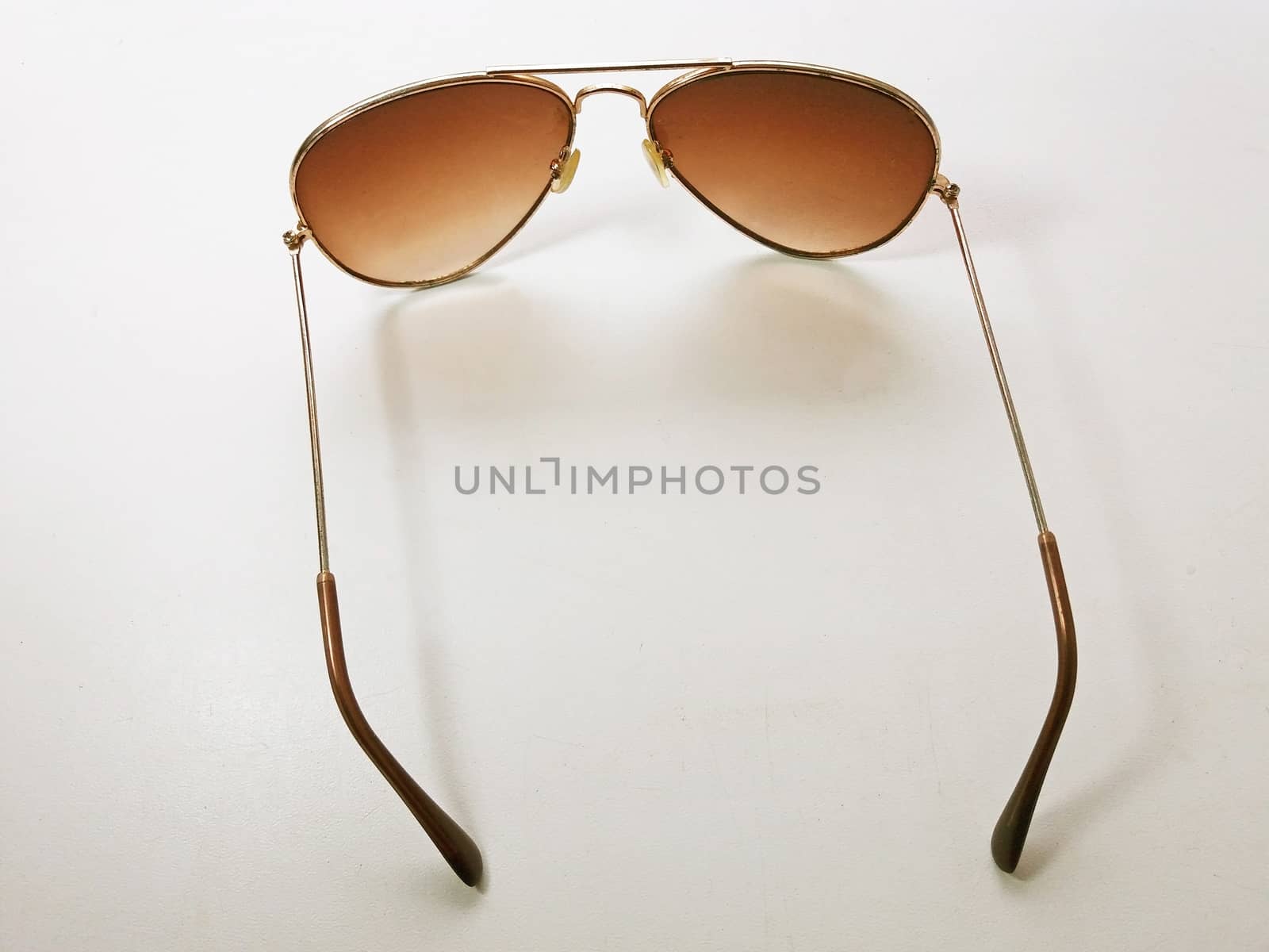 Nice sunglases on white background glasses with brown glass