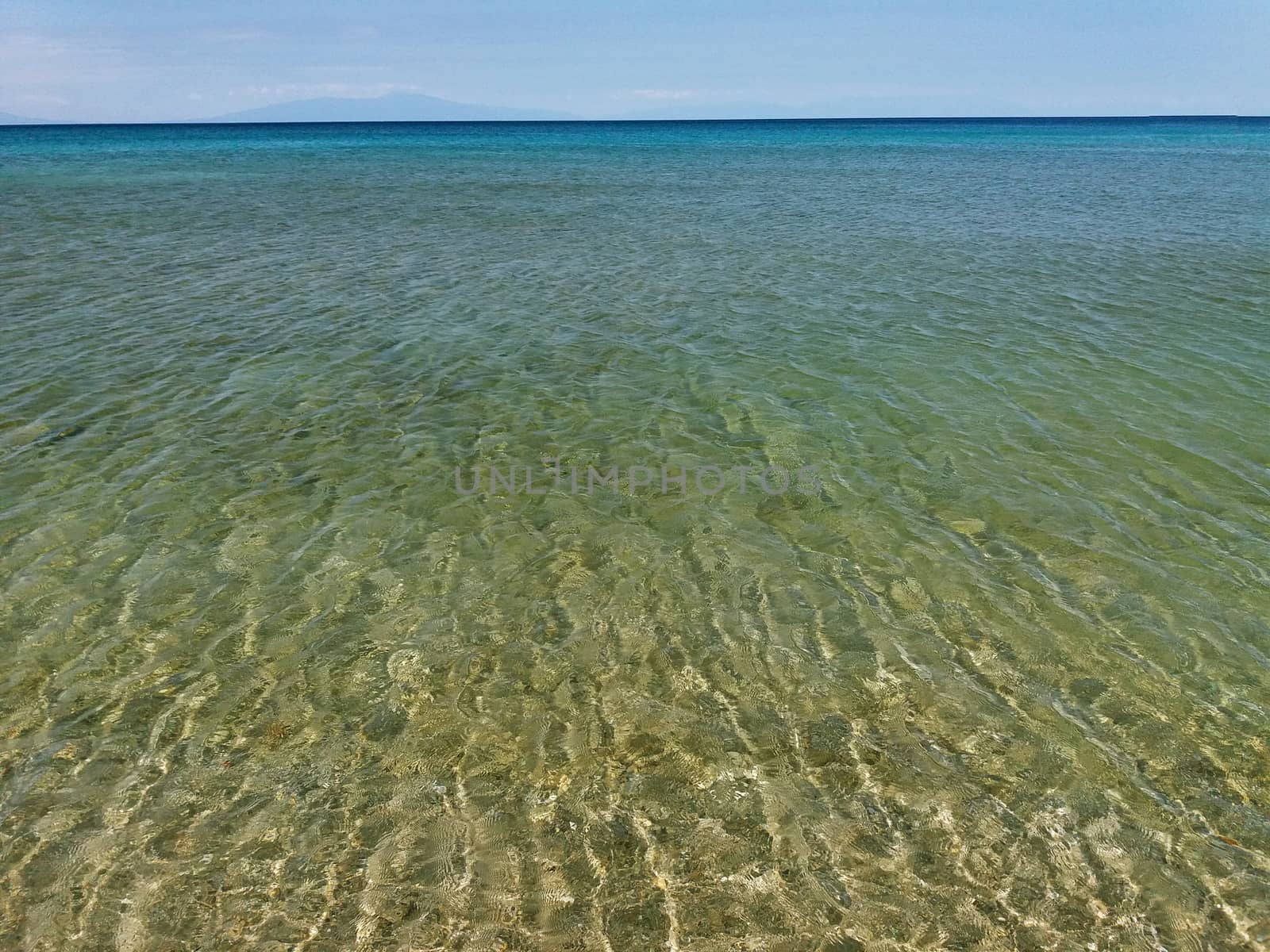 The Mediterranean Sea in Greece, clear green and blue water by Mindru