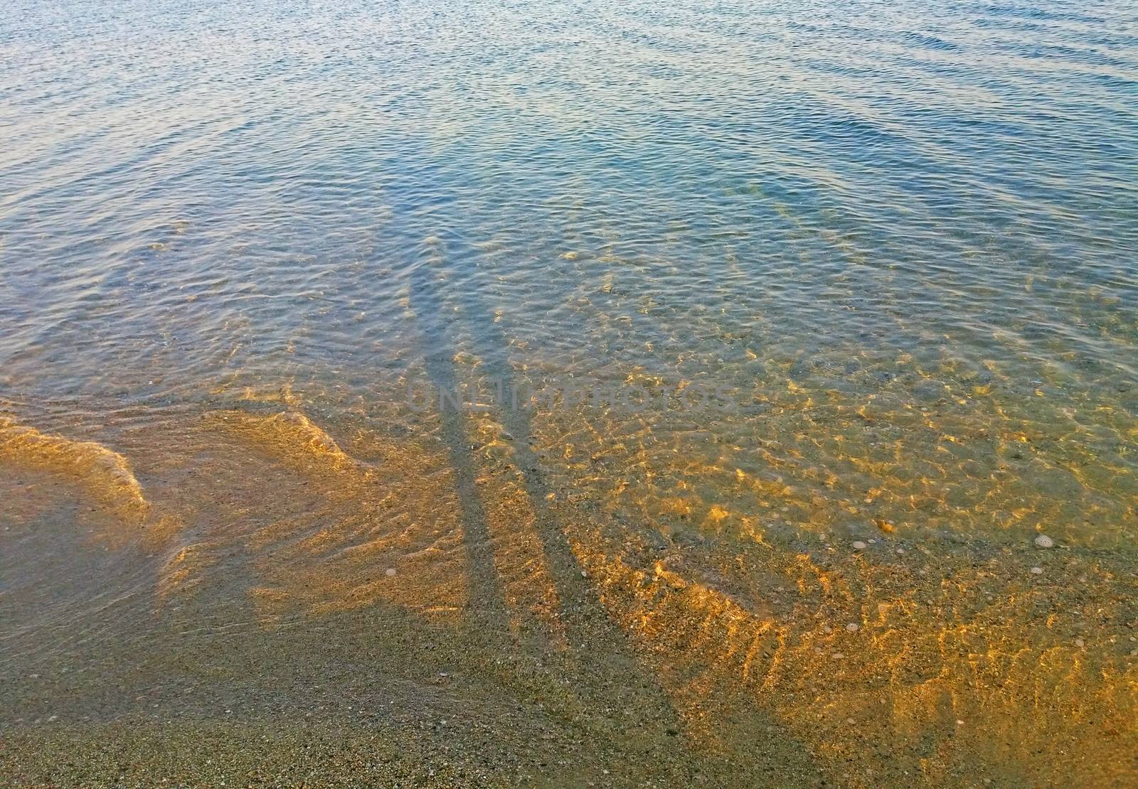 The Mediterranean Sea at sunrise, shadow of a man