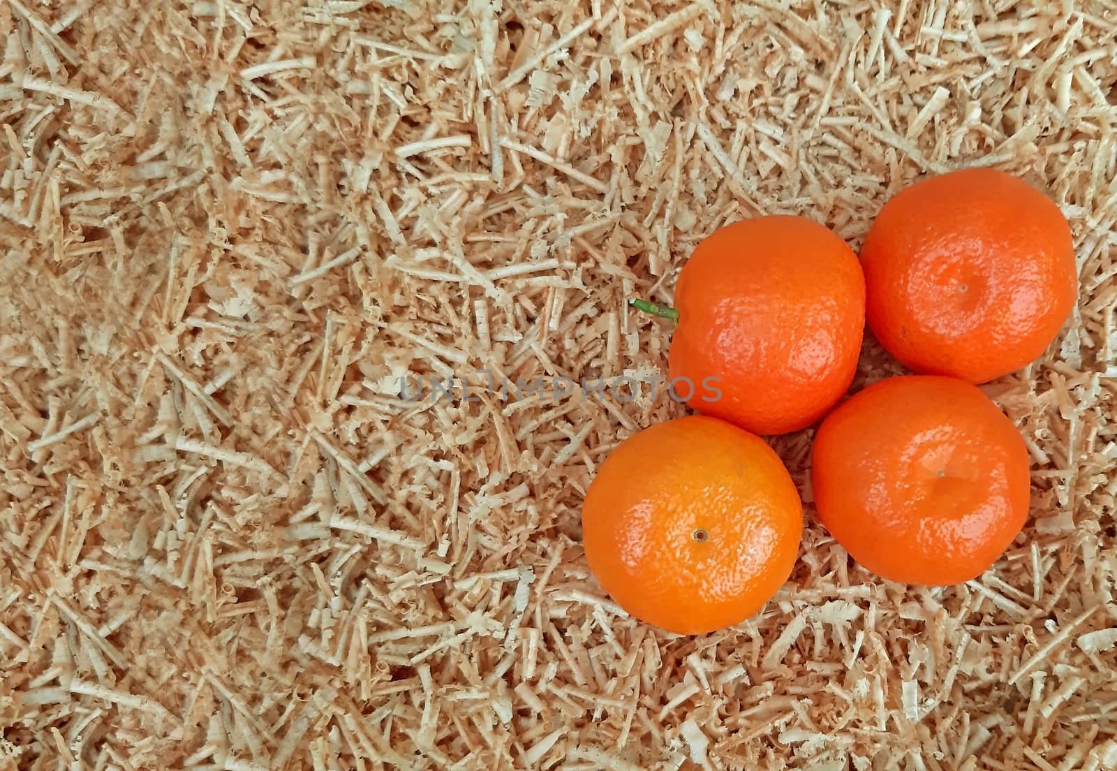 Clementines on a background of sawdust