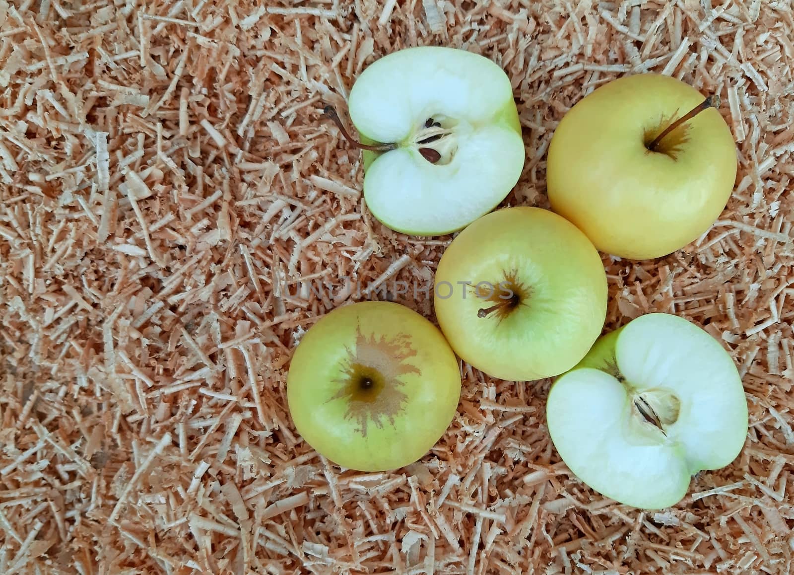 White apples on the background of sawdust.