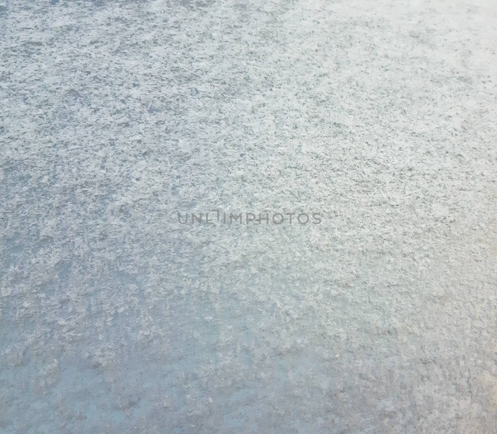Snowy texture on the hood of a car.