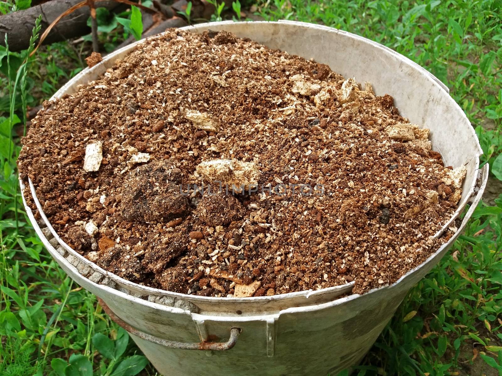 A bucket full of humus close up by Mindru