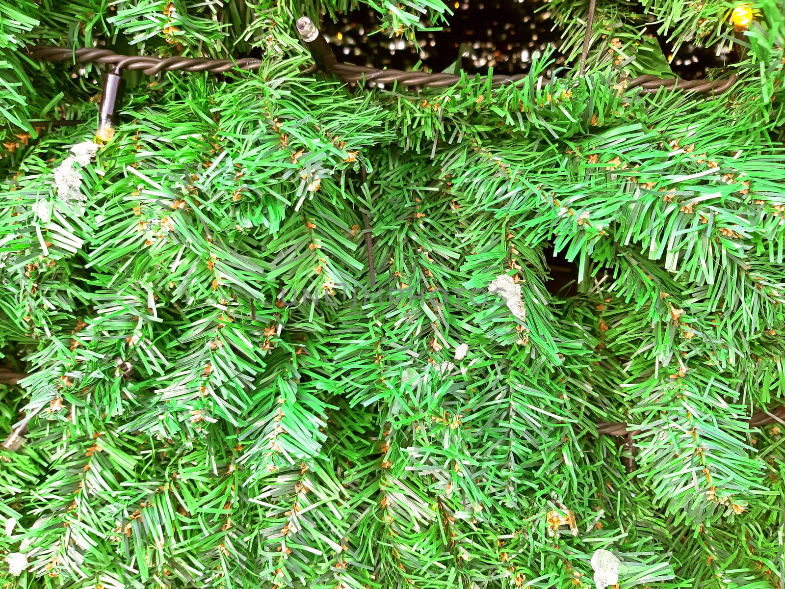 Artificial green decorative christmas tree close up.