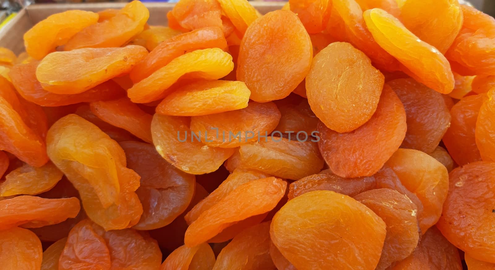 Dried apricots natural food concept, textured close up by Mindru