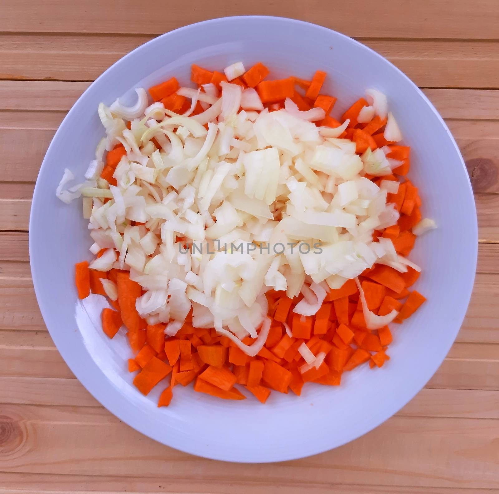 Onion and carrot cut into a plate by Mindru