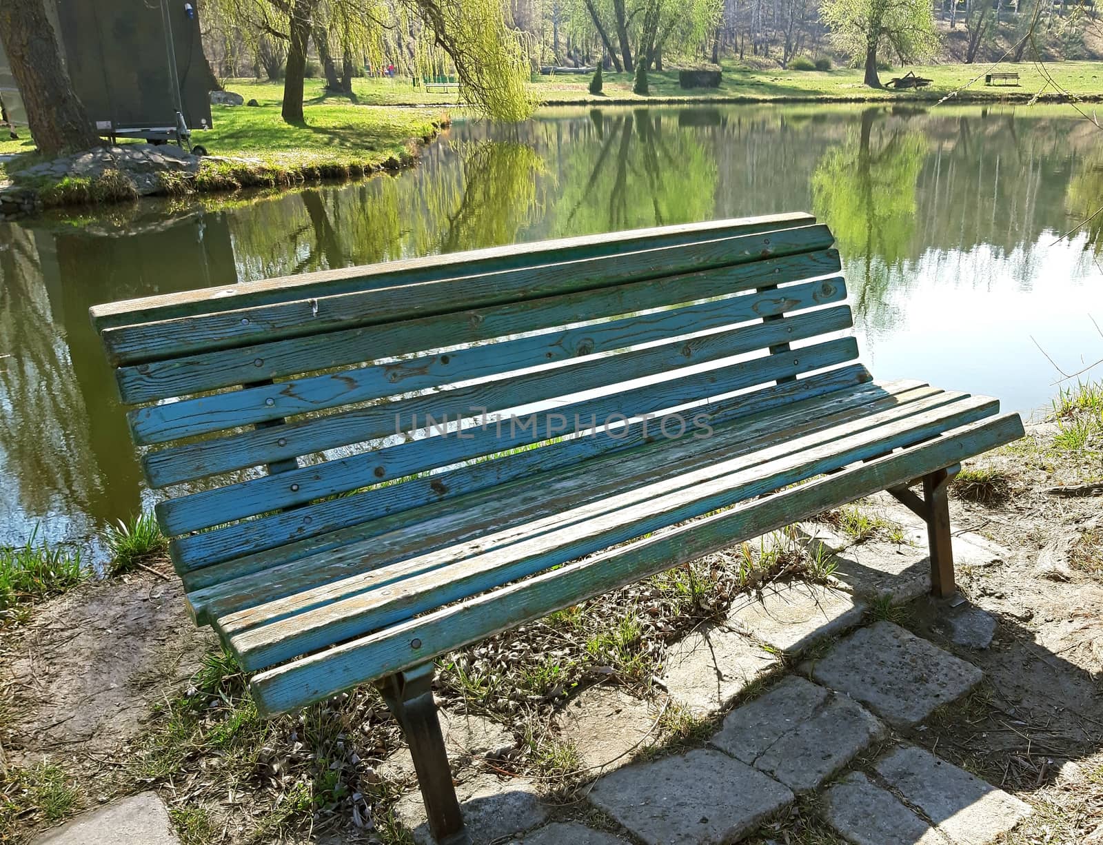 Bench on the shore of a lake by Mindru