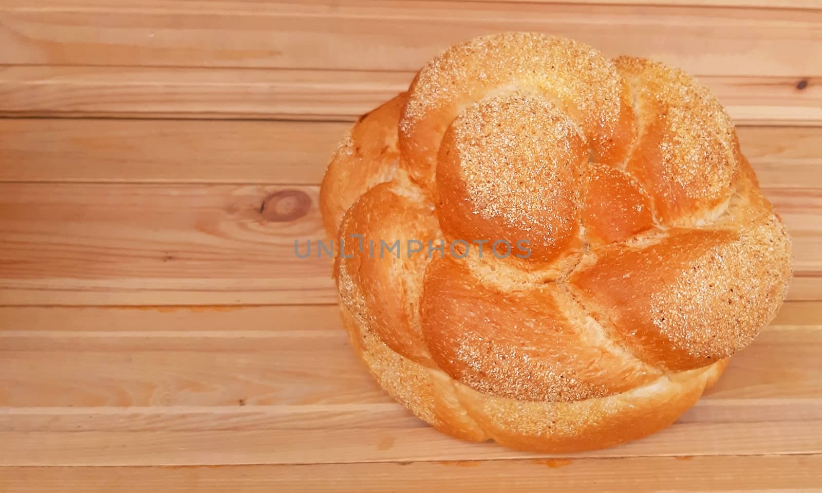 Home-made bread on wooden background close up.