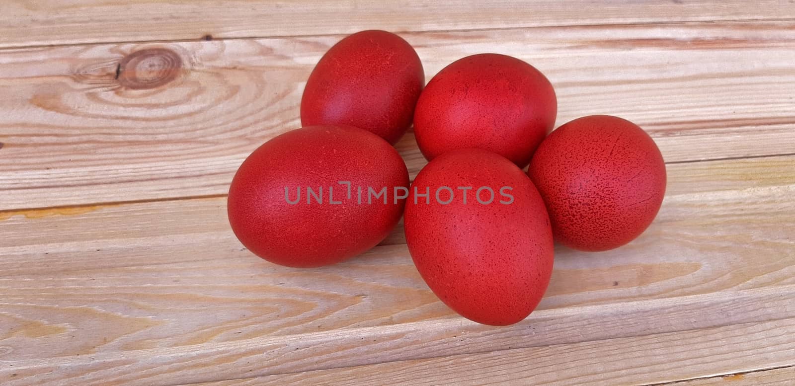 Red eggs on wooden background, Easter holiday by Mindru