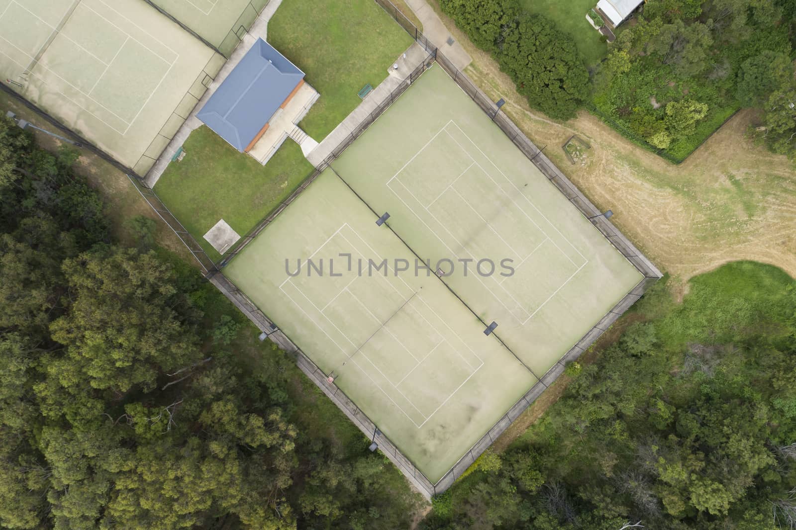 An aerial view of a tennis court in a small regional town by WittkePhotos