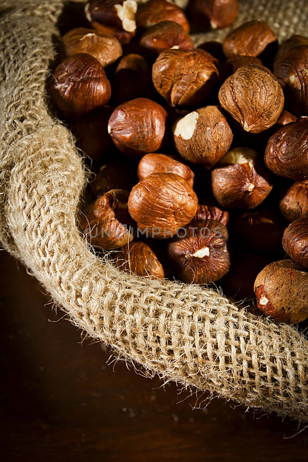 Unpeeled hazelnuts in a bag close up