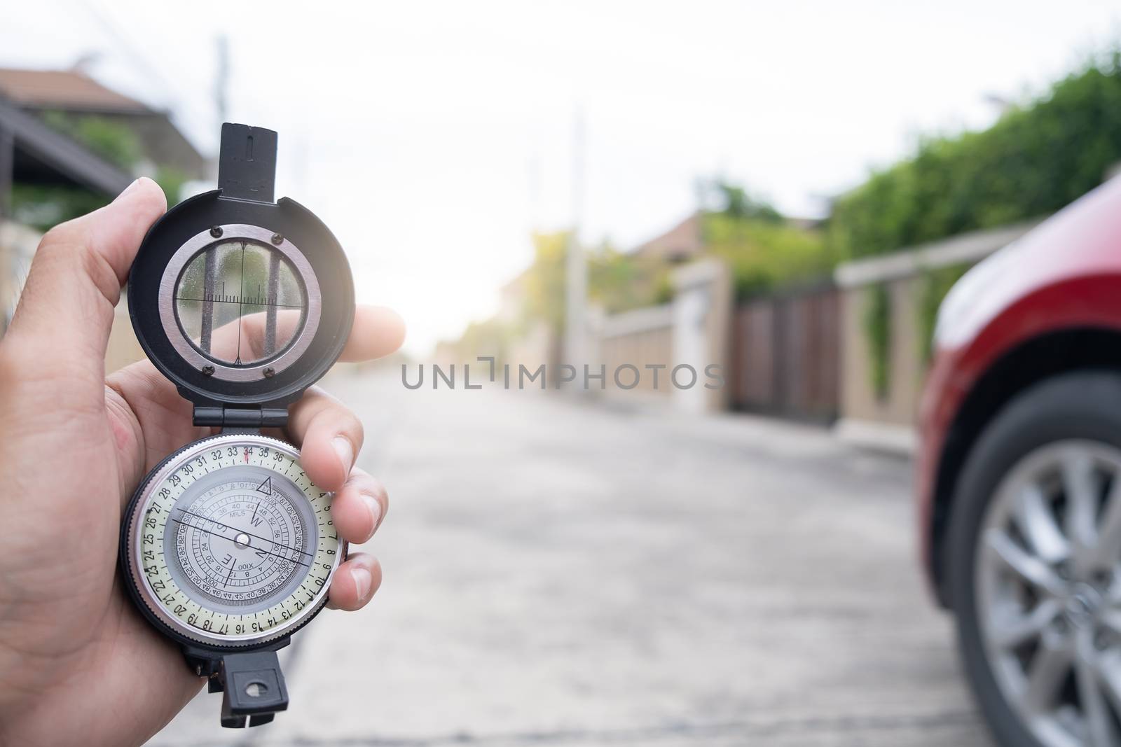 man holding compass on blurred background. for activity lifestyle outdoors freedom or travel tourism and inspiration backpacker alone tourist travel or navigator image.