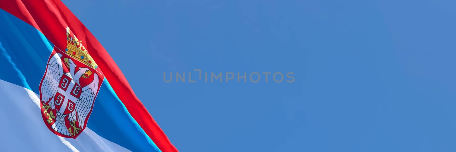 3D rendering of the national flag of Serbia waving in the wind against a blue sky