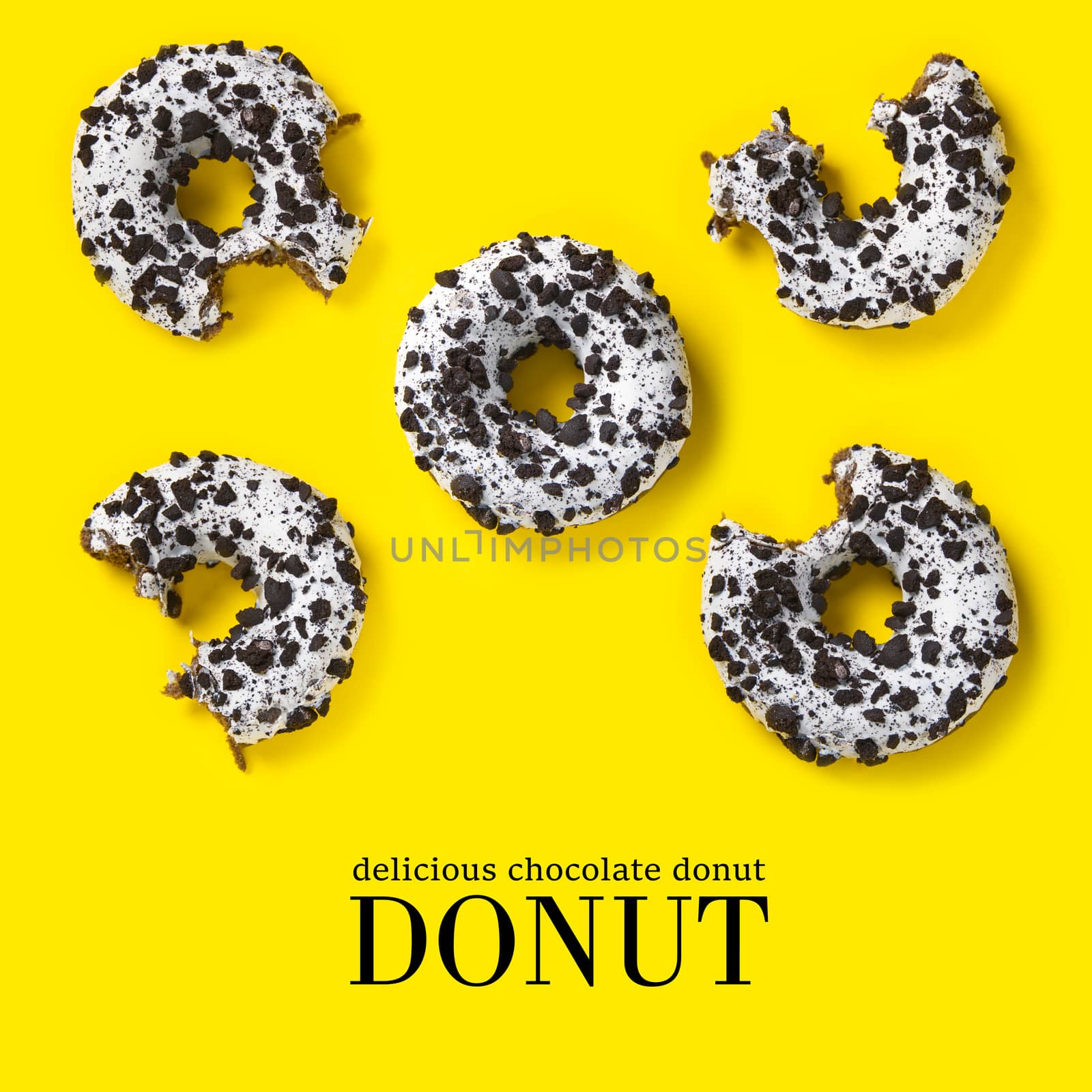 creative composition of donuts on a yellow background. Flat lay delicious nibbled chocolate donuts and simple text.