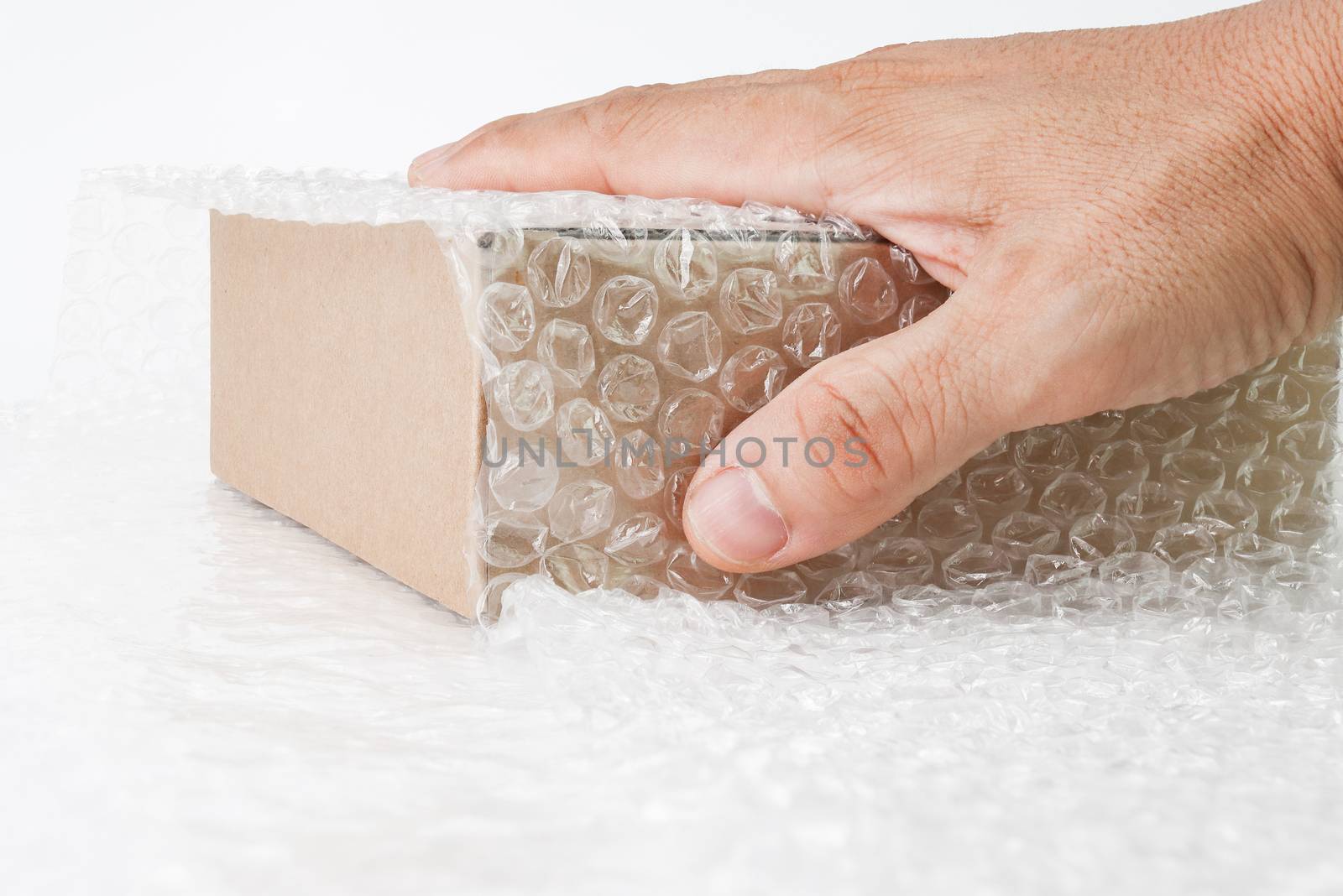 hand of man hold Bubbles covering the box by bubble wrap for protection product cracked  or insurance During transit -isolated white background 
