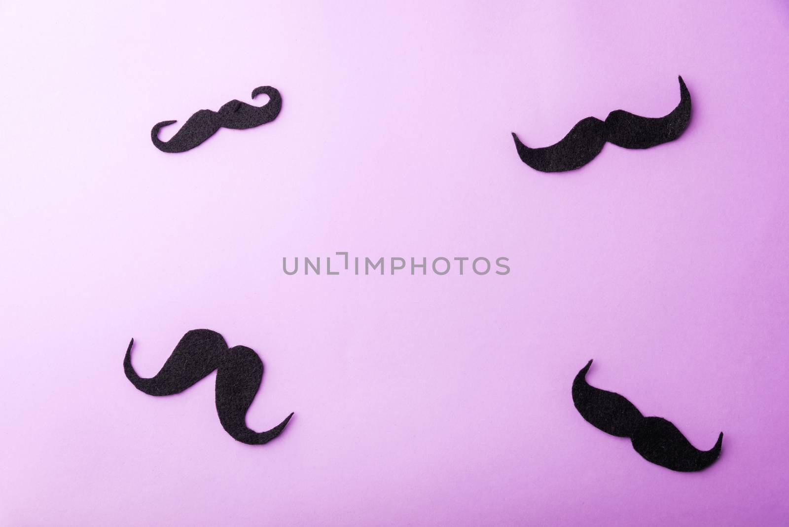 Black mustache paper, studio shot isolated on purple background, Prostate cancer awareness month, Fathers day, minimal November moustache concept