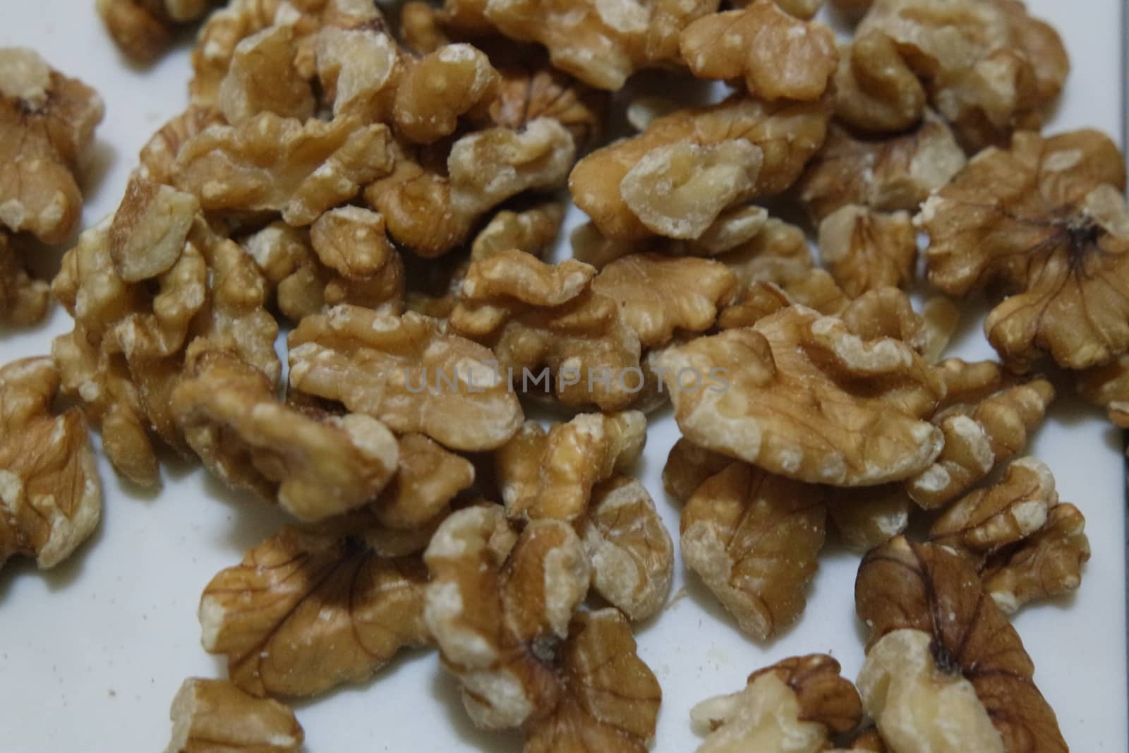 Close-up top view of peeled walnut on a white background. peeled walnut without shell ready to eat dry fruit.