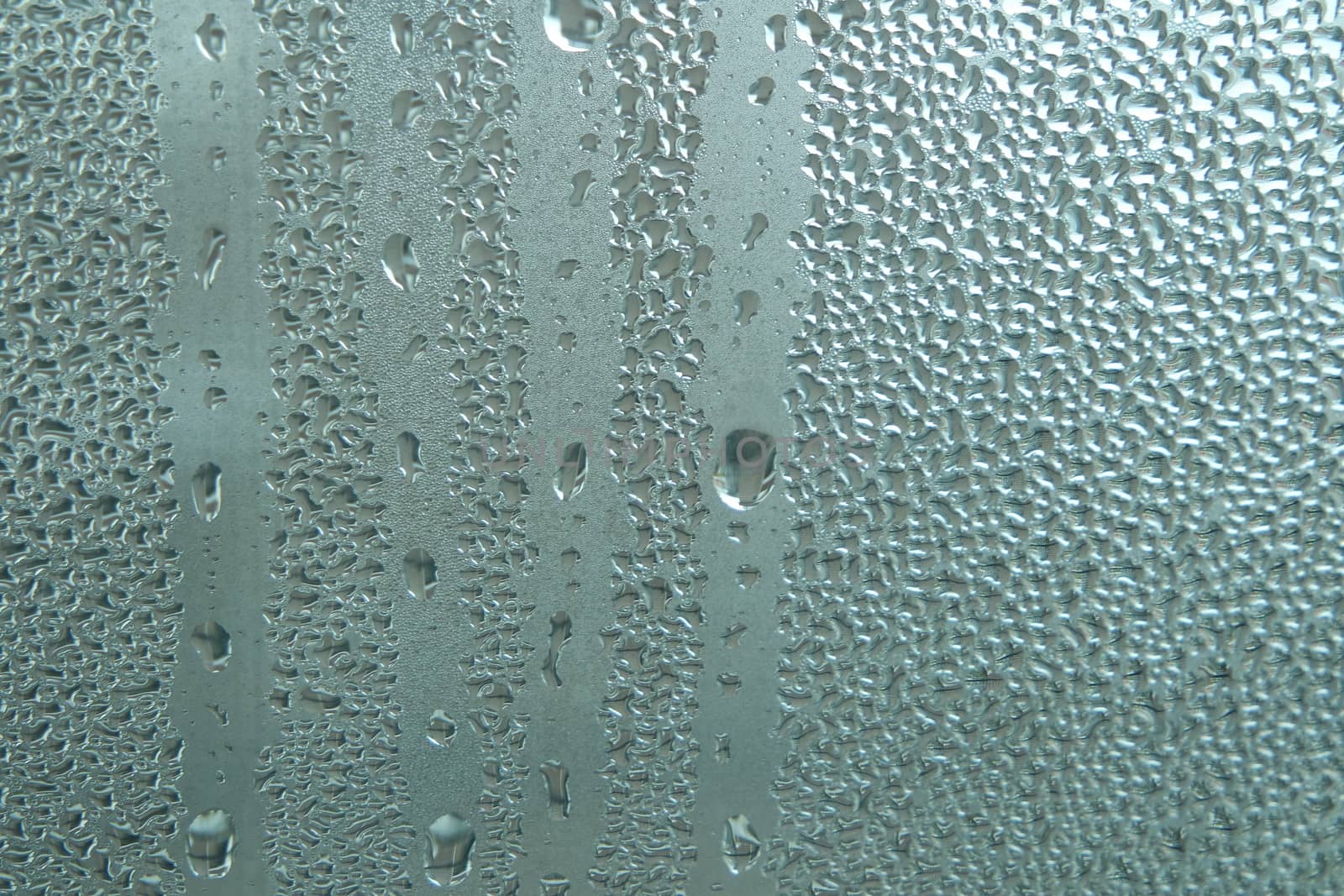 Bright grey color glassy texture, with water drops on it. Water drop glassy background