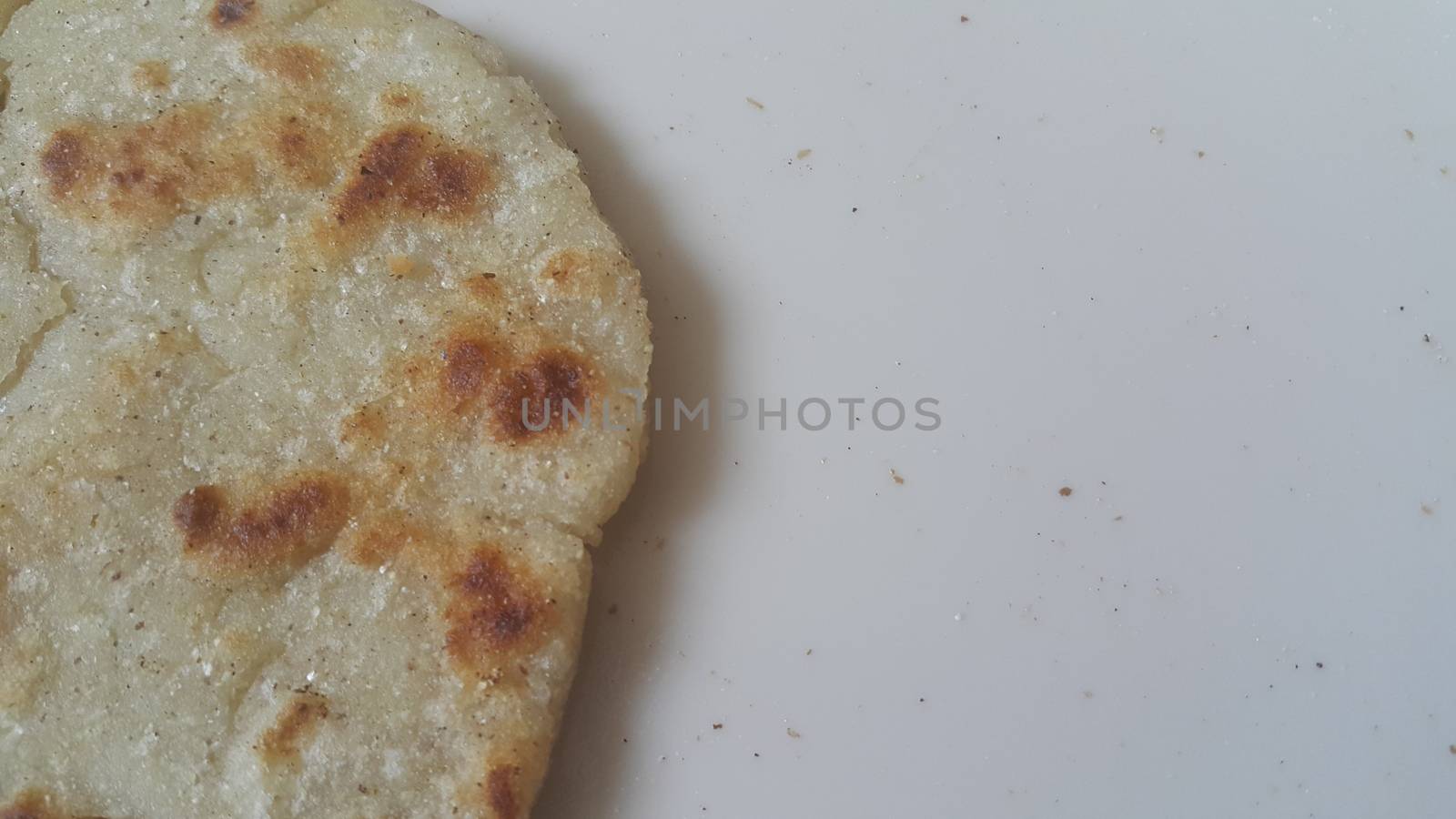 Closeup view of of traditional bread called Jawar roti or bhakri on white background. Bhakri is a round flat unleavened bread often used in the cuisine of many Asian countries