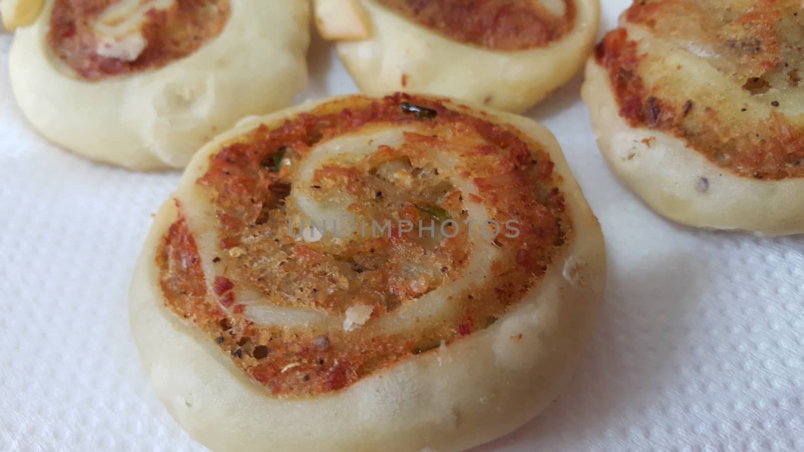 Closeup of delicious home made pinwheel puff pastries food item placed over white background