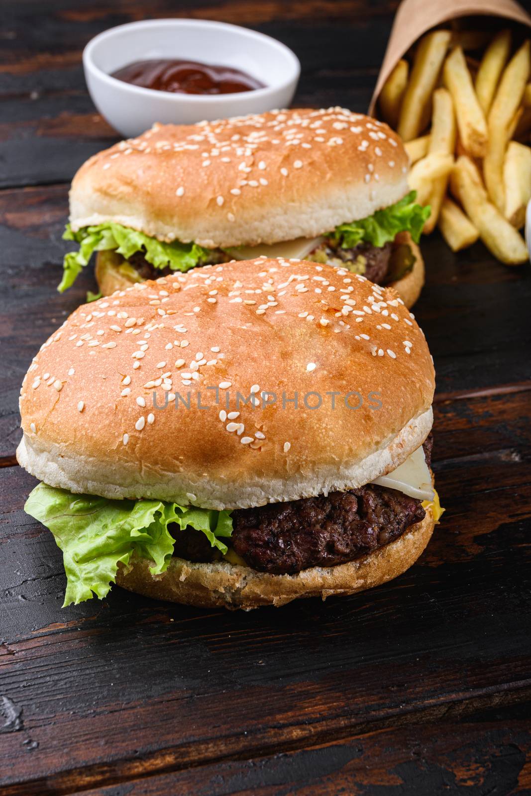 Two grilled angus burger with cheese on wooden table by Ilianesolenyi
